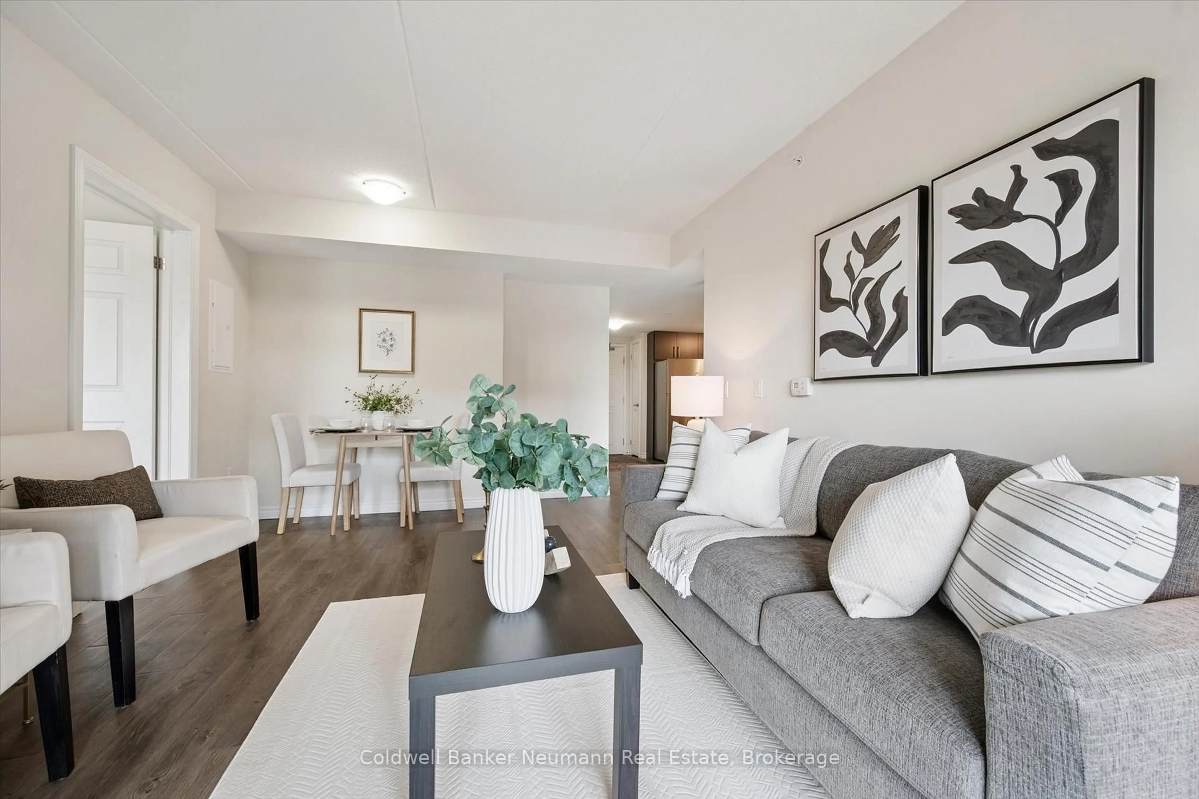 Living room with furniture, wood/laminate floor for 7 Kay Cres #212, Guelph Ontario N1L 0P9