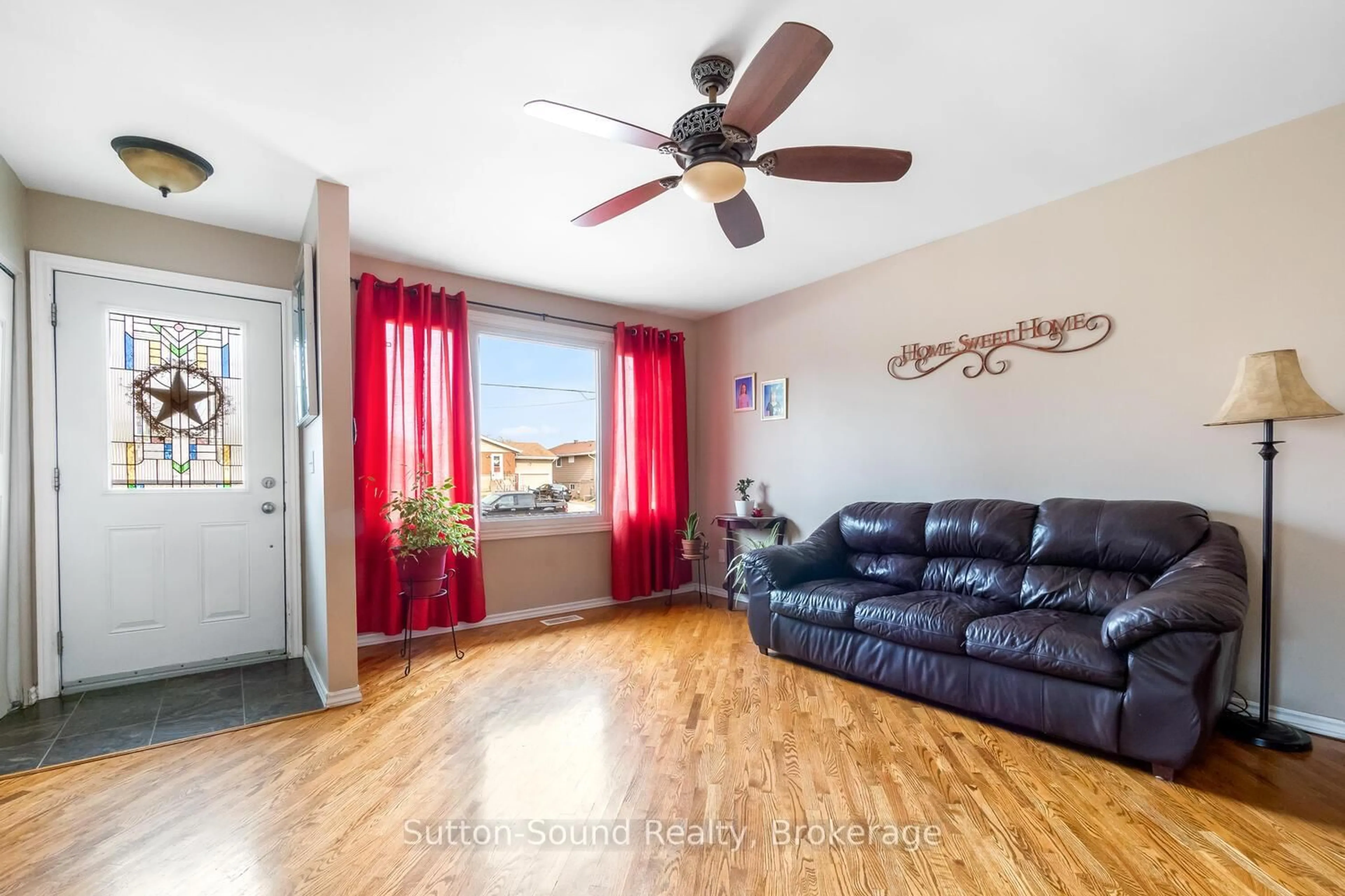 Living room with furniture, wood/laminate floor for 2041 8th Ave, Owen Sound Ontario N4K 3C5