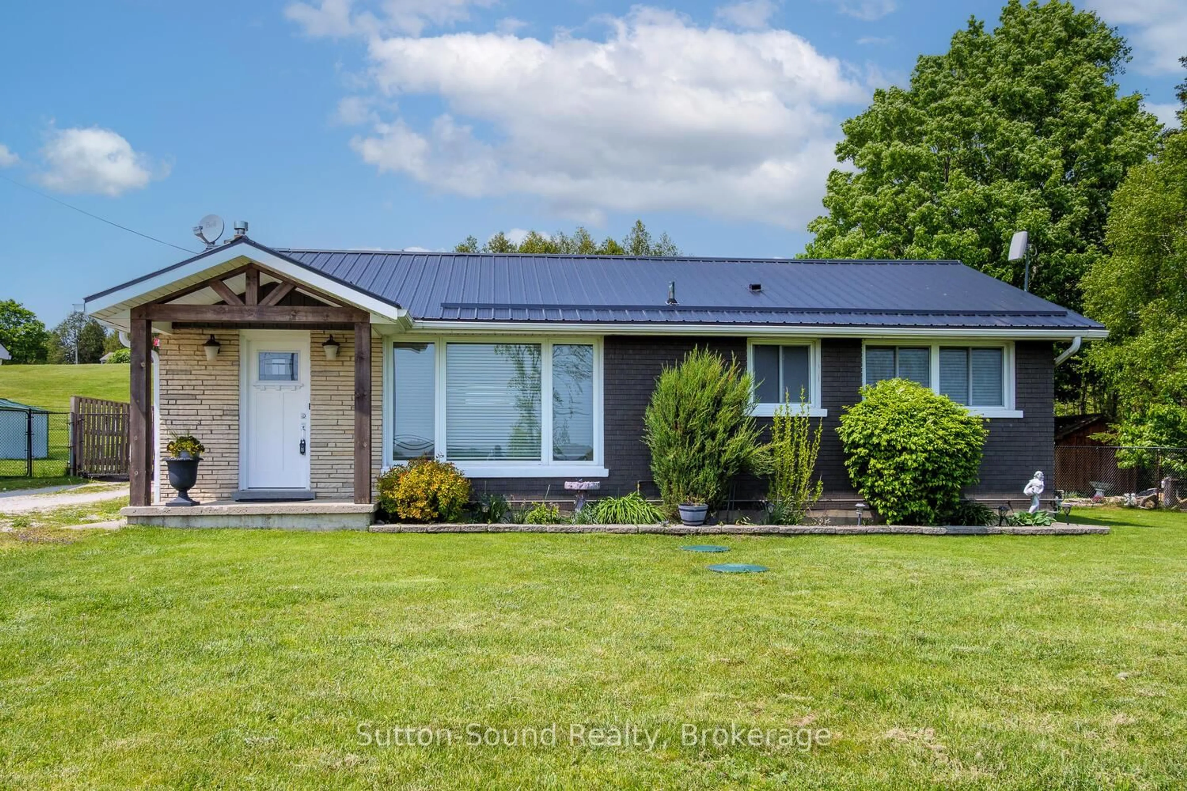 Home with vinyl exterior material, street for 202093 21 Highway, Georgian Bluffs Ontario N4K 5N7
