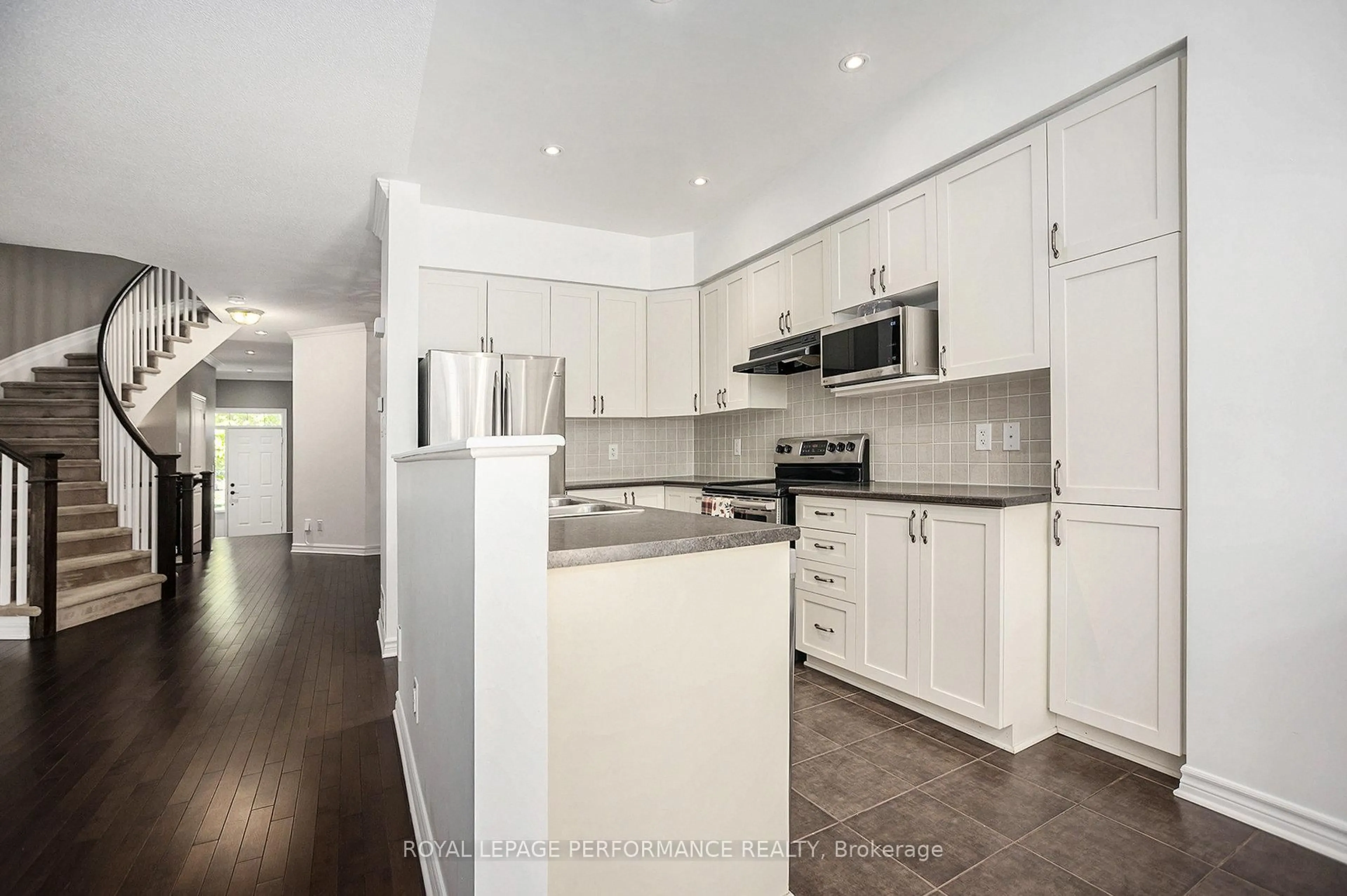 Open concept kitchen, wood/laminate floor for 40 Torbec Ave, Ottawa Ontario K2T 0B5