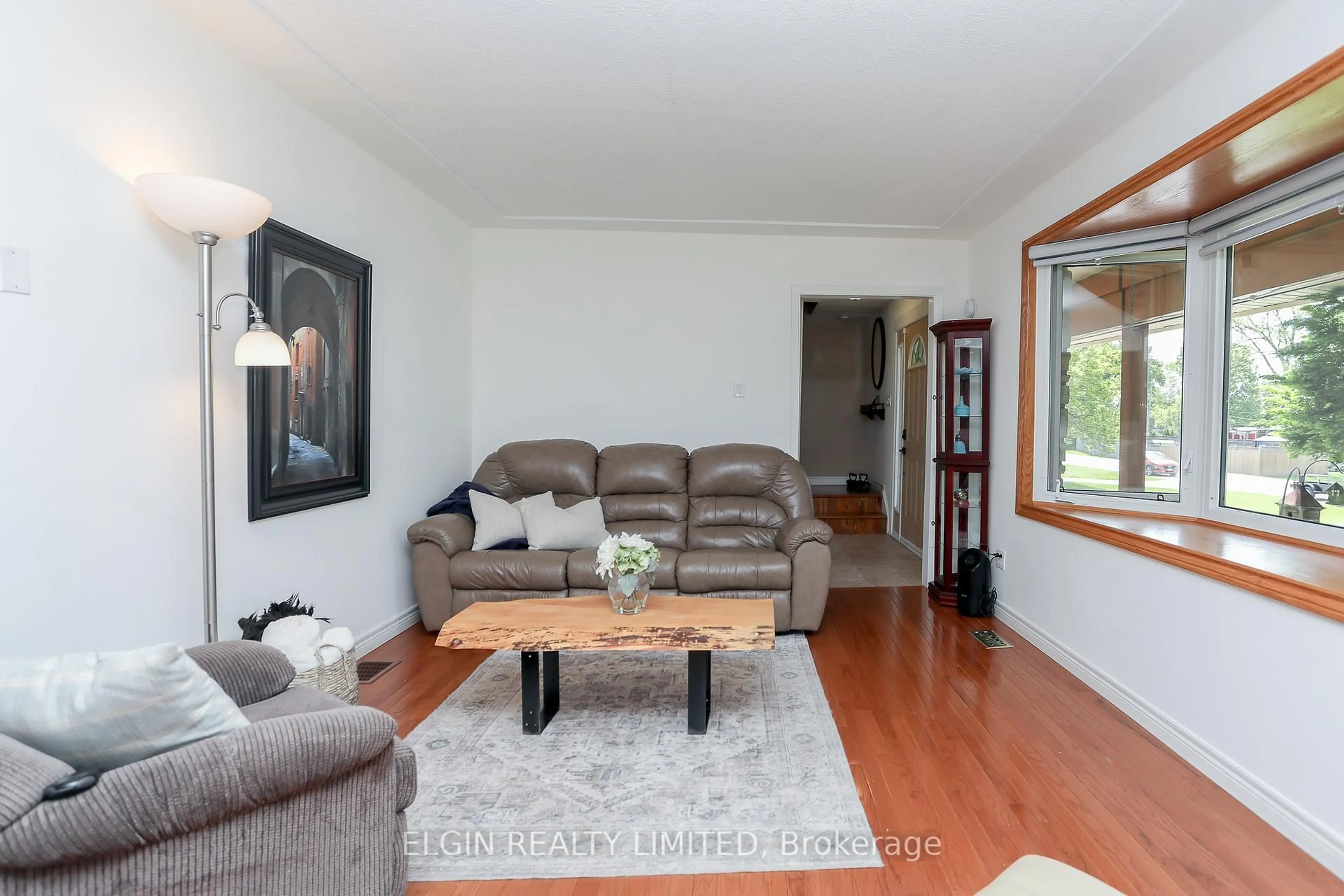 Living room with furniture, wood/laminate floor for 10201 Lynhurst Park Dr, Southwold Ontario N5P 2E5