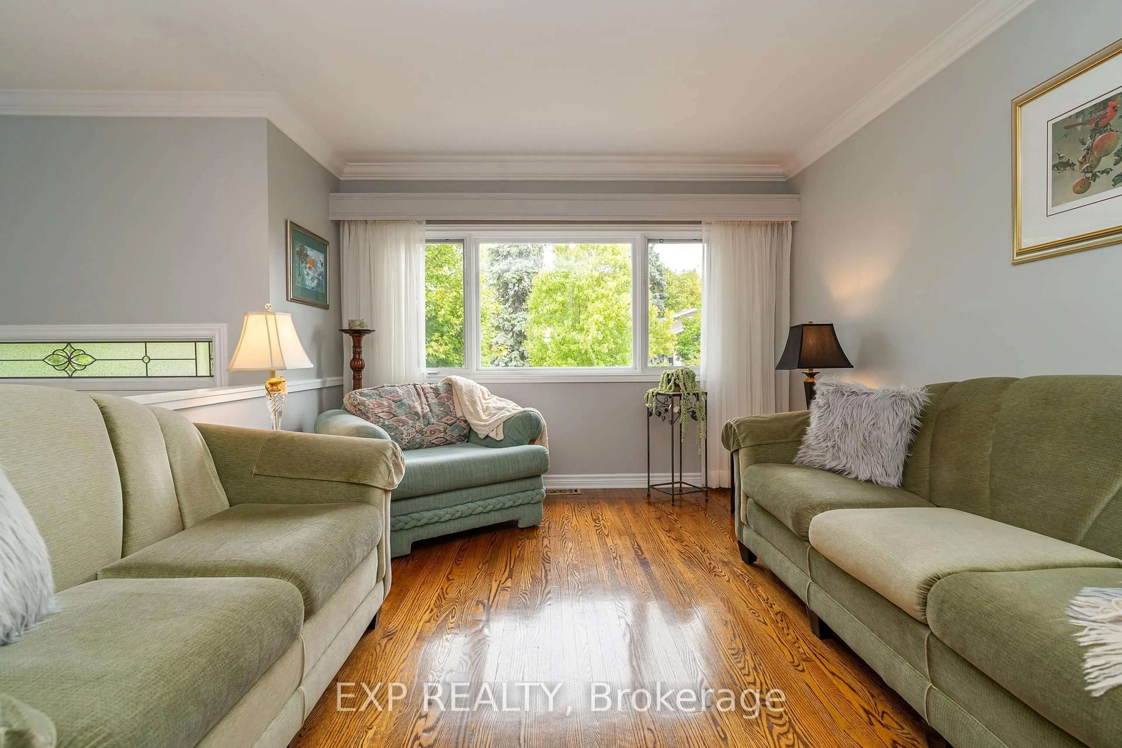 Living room with furniture, wood/laminate floor for 1828 Lorraine Ave, Ottawa Ontario K1H 6Z8