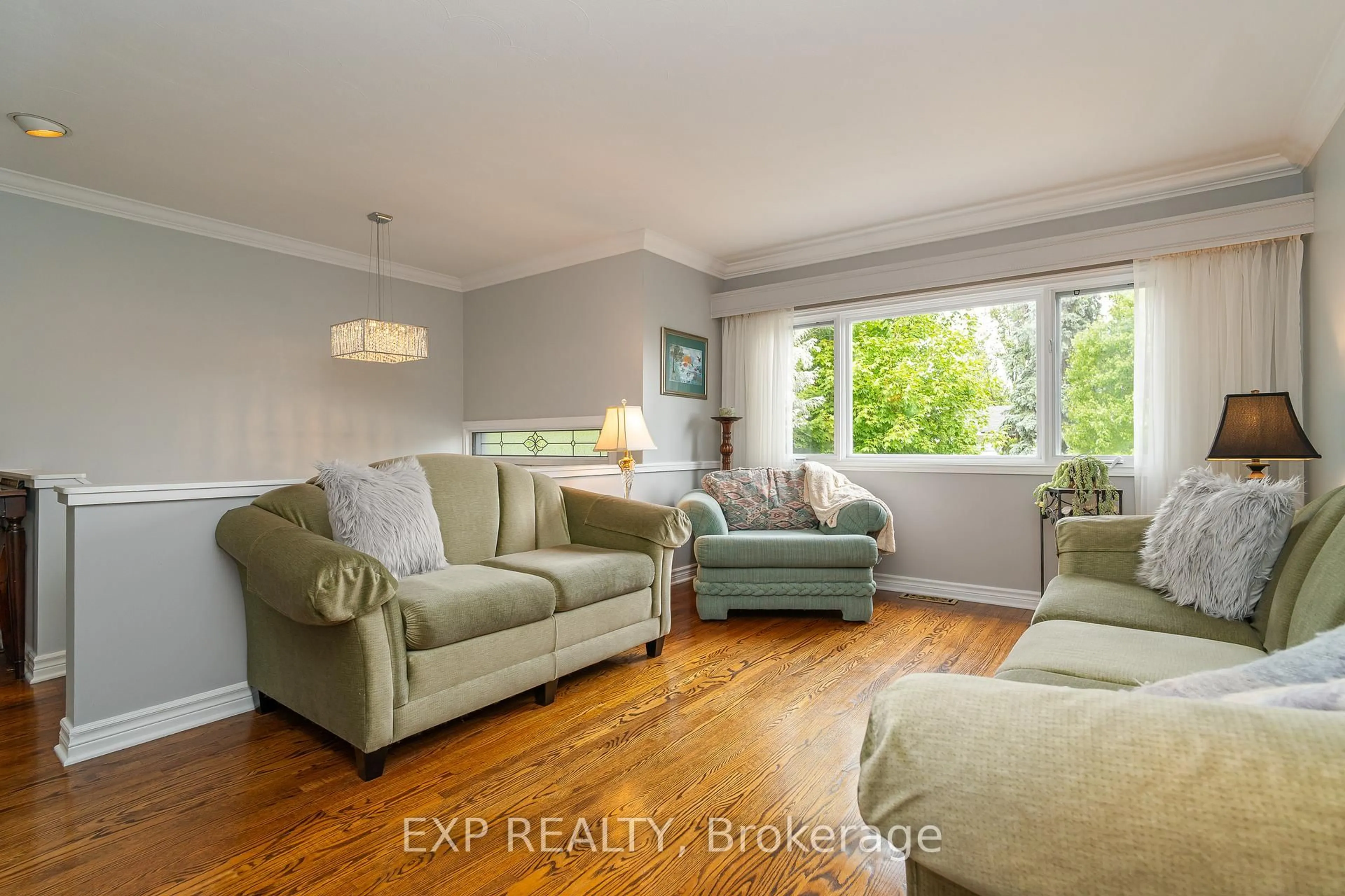 Living room with furniture, wood/laminate floor for 1828 Lorraine Ave, Ottawa Ontario K1H 6Z8