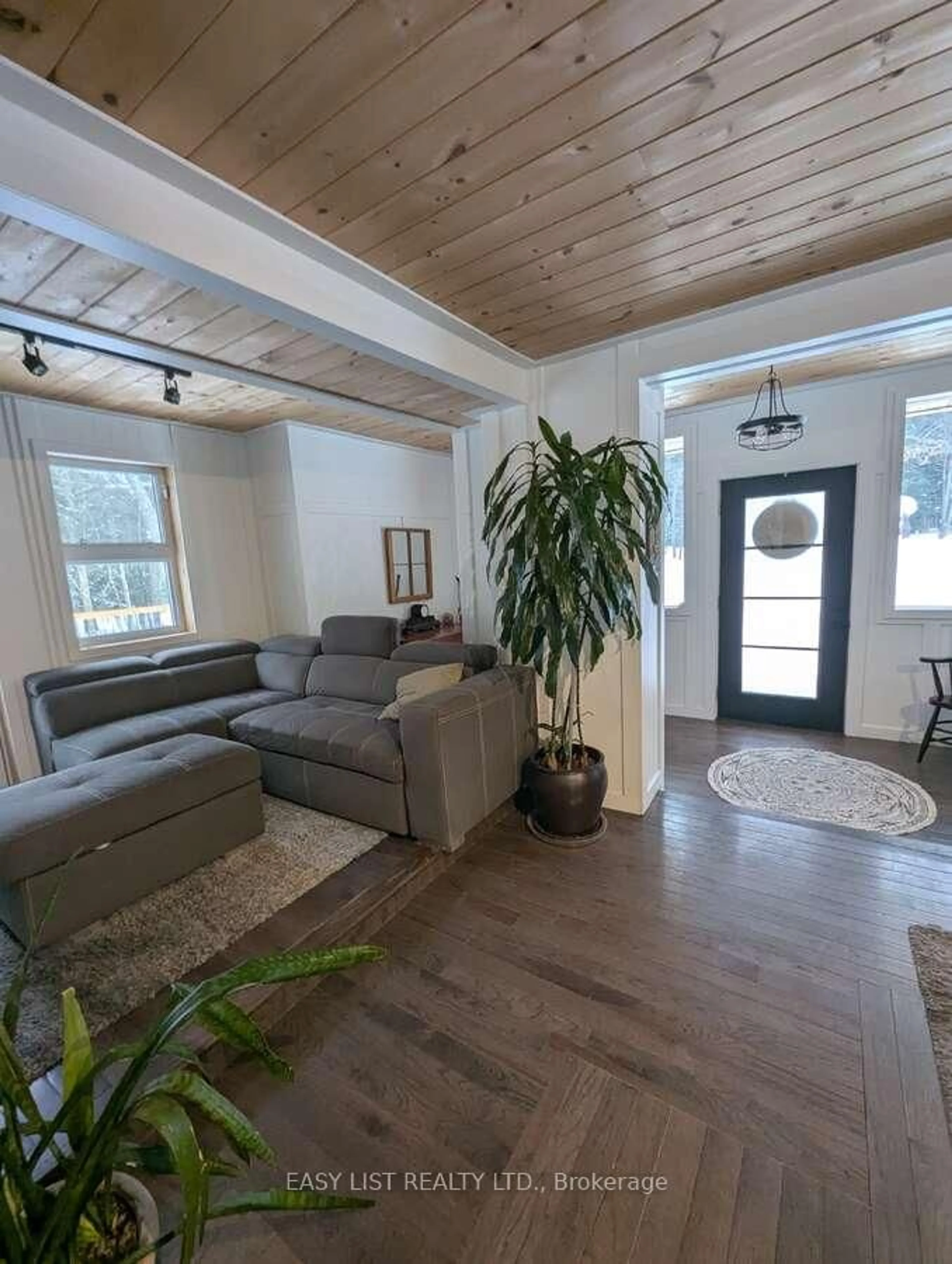 Living room with furniture, wood/laminate floor for 22 Camp Rd, McKellar Ontario P2A 0B4
