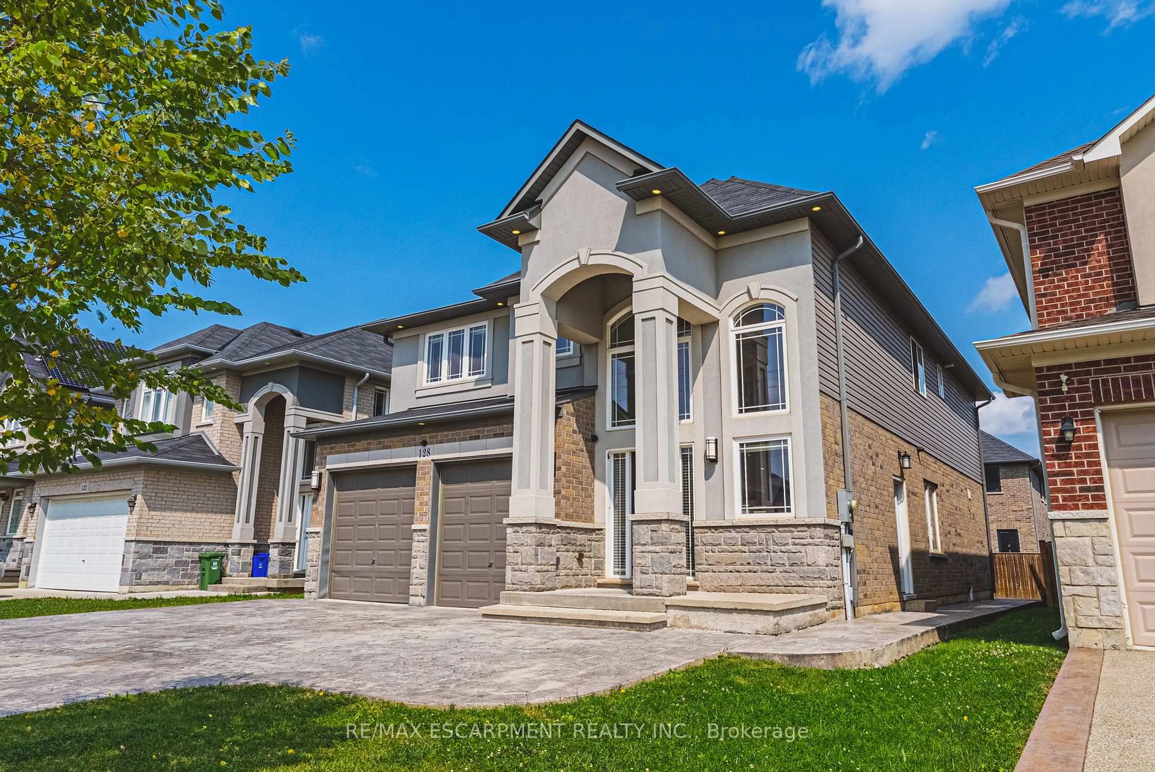 Home with brick exterior material, street for 128 Medici Lane, Hamilton Ontario L0R 1W0
