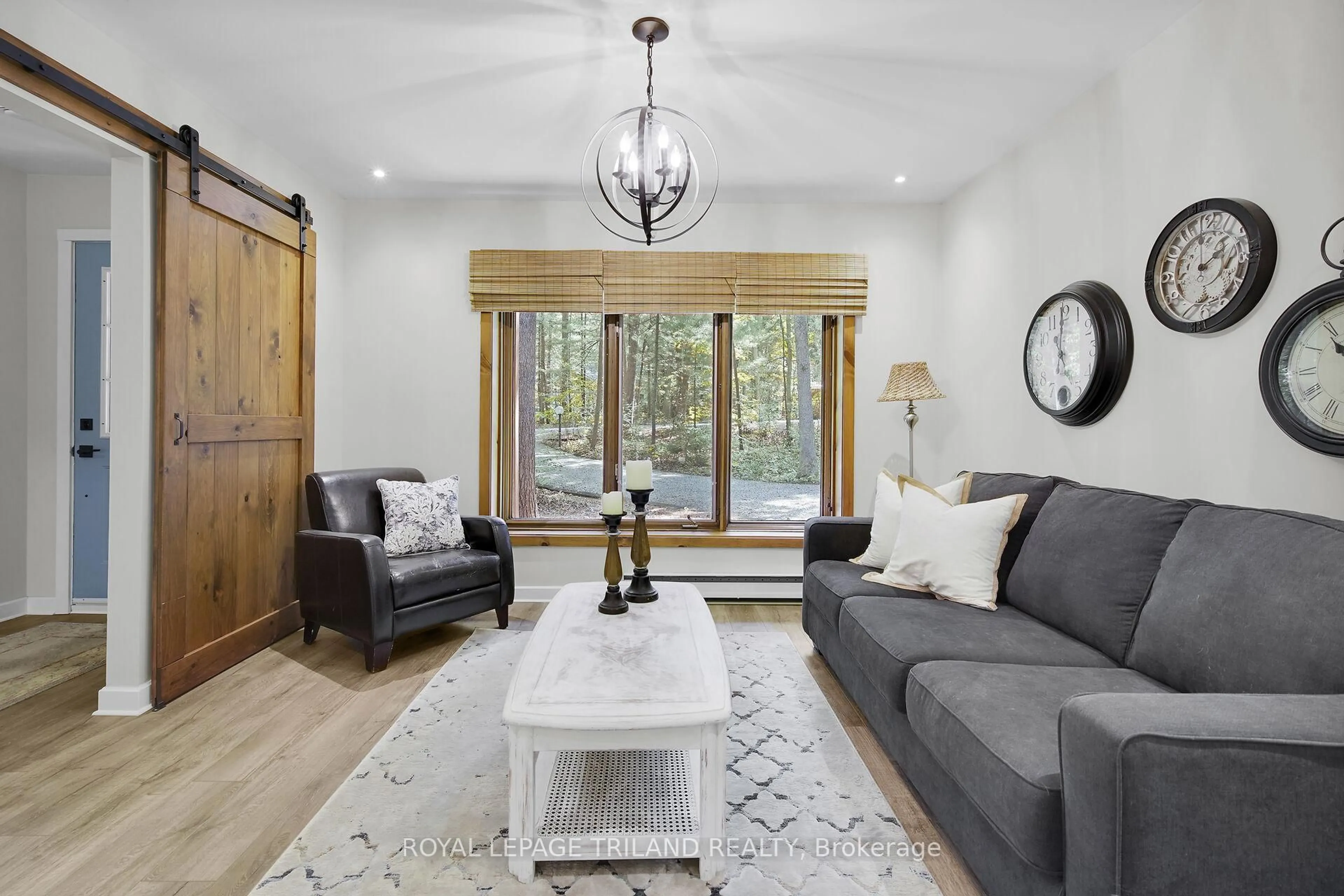 Living room with furniture, wood/laminate floor for 10087 Beaver Dam Cres, Lambton Shores Ontario N0M 1T0