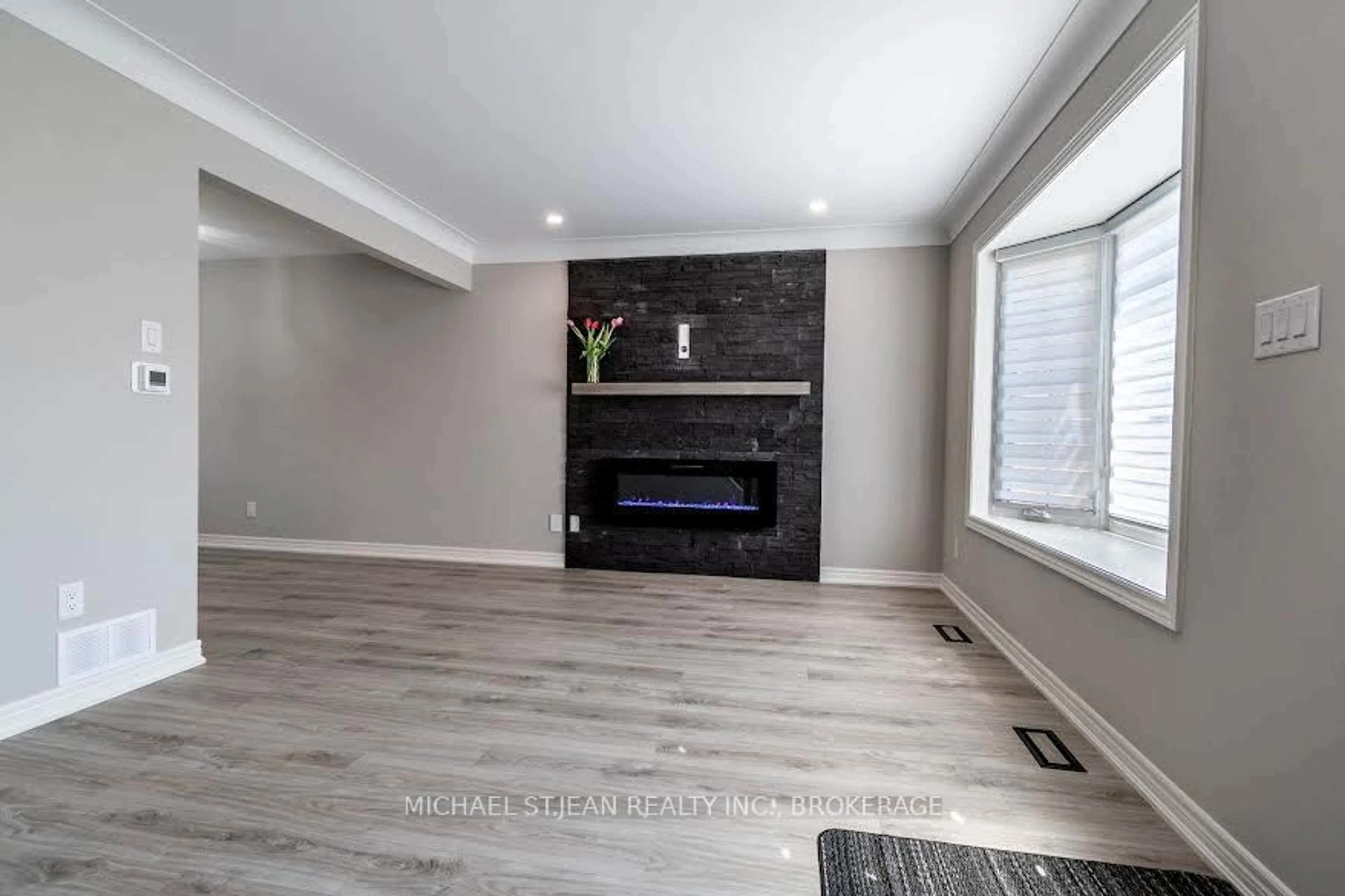 Living room with furniture, wood/laminate floor for 261 Scott St #B, St. Catharines Ontario L2N 1H9