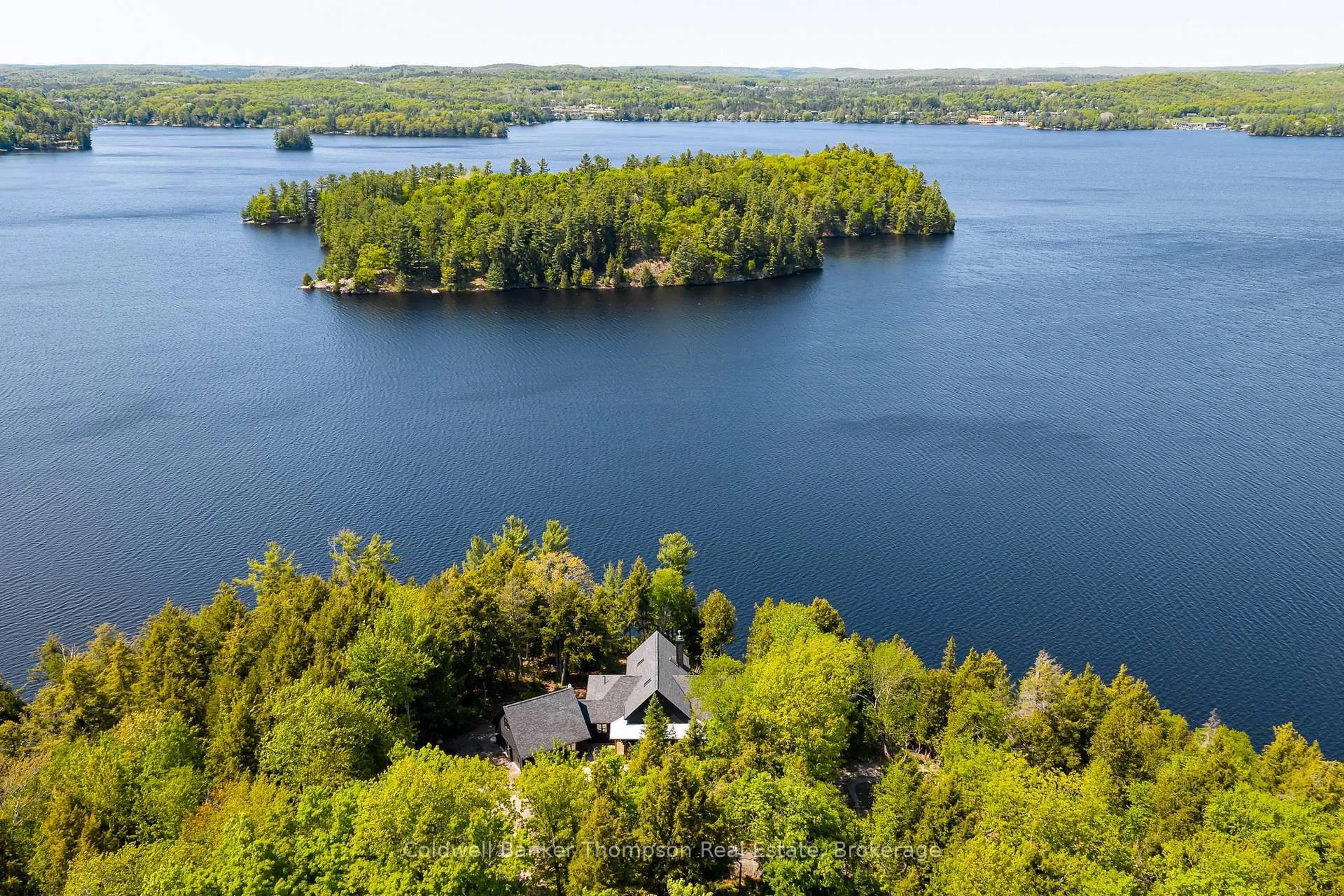 A pic from outside/outdoor area/front of a property/back of a property/a pic from drone, water/lake/river/ocean view for 59 Waters Edge Lane, Huntsville Ontario P1H 0H9