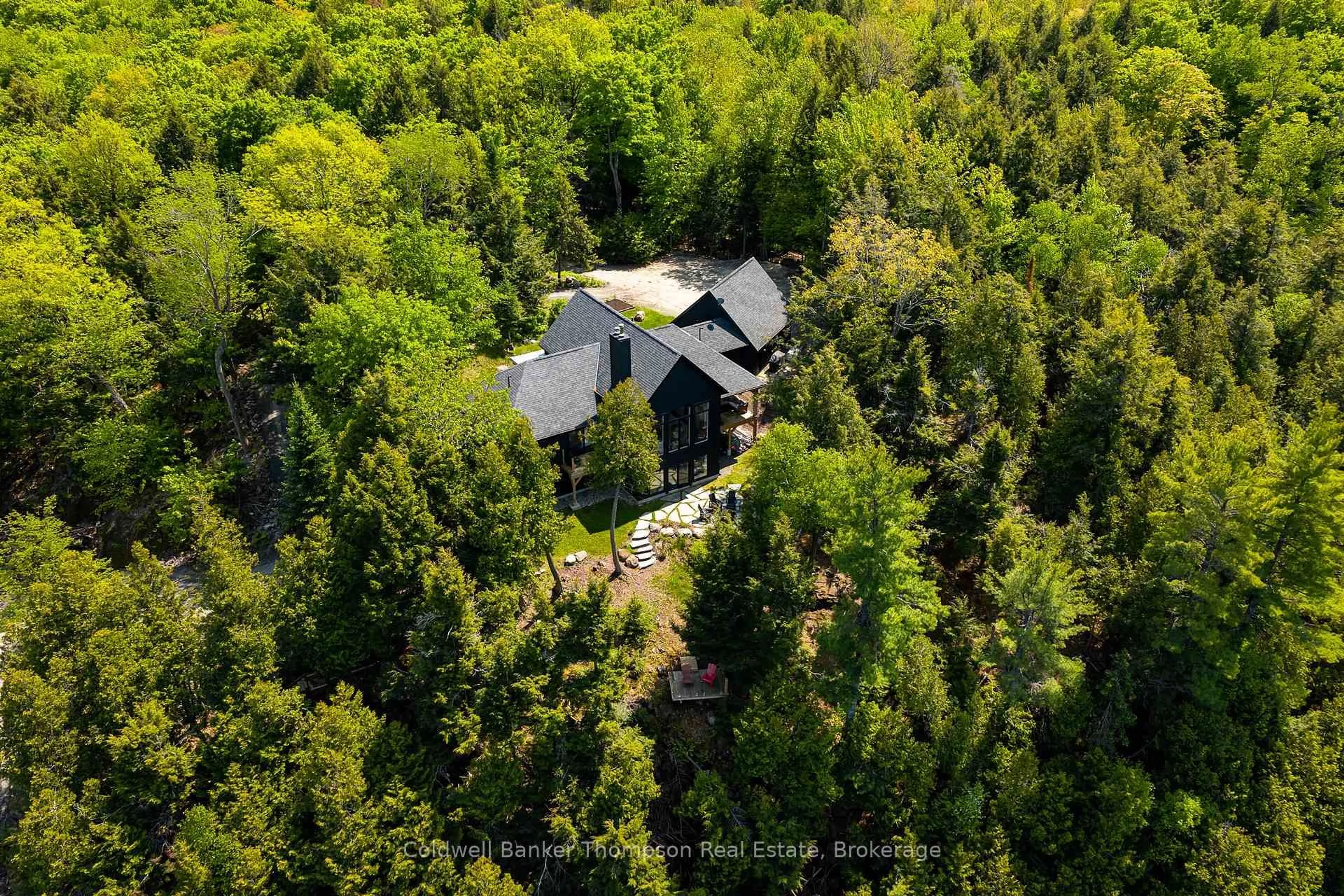 A pic from outside/outdoor area/front of a property/back of a property/a pic from drone, forest/trees view for 59 Waters Edge Lane, Huntsville Ontario P1H 0H9