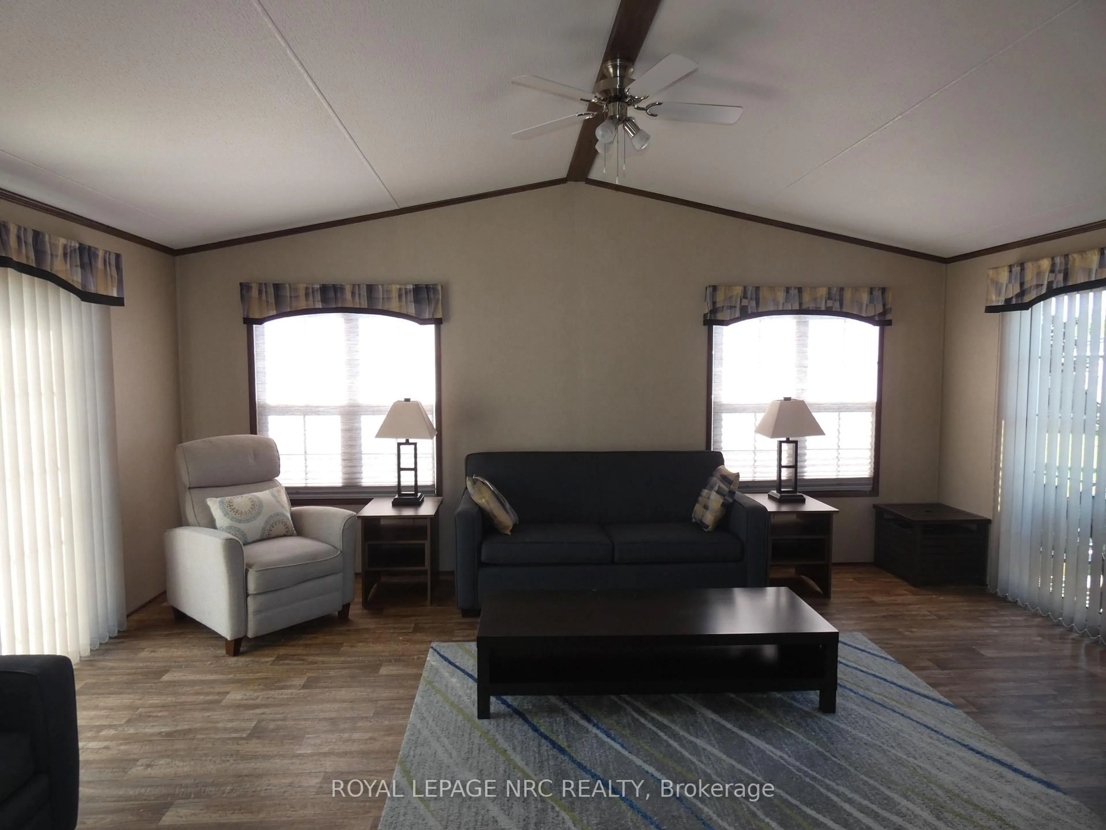 Living room with furniture, wood/laminate floor for 1501 Line 8 Rd #110, Niagara-on-the-Lake Ontario L0S 1J0