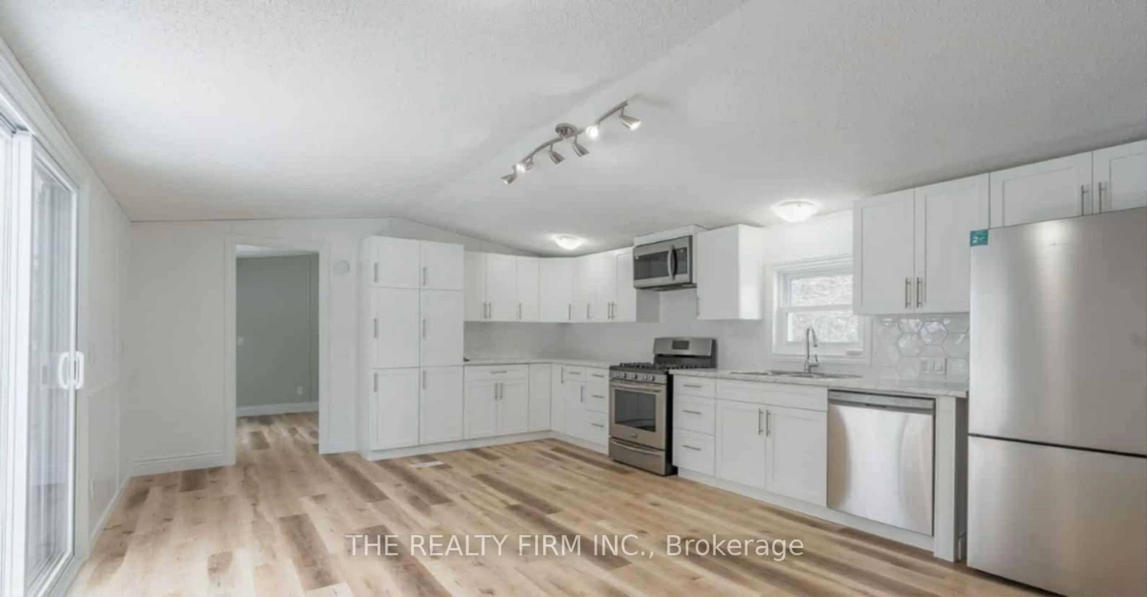Open concept kitchen, wood/laminate floor for 75049 Hensall Rd #18, Huron East Ontario N0K 1W0