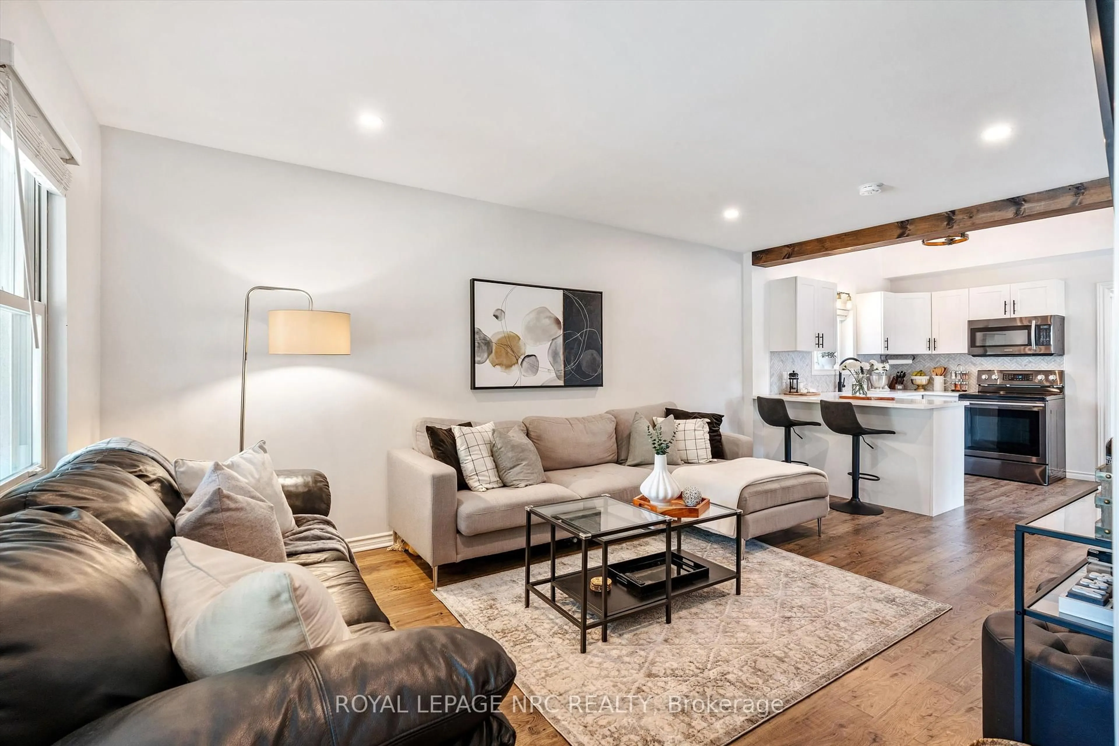 Living room with furniture, wood/laminate floor for 264 Lakeshore Rd, St. Catharines Ontario L2M 7R3