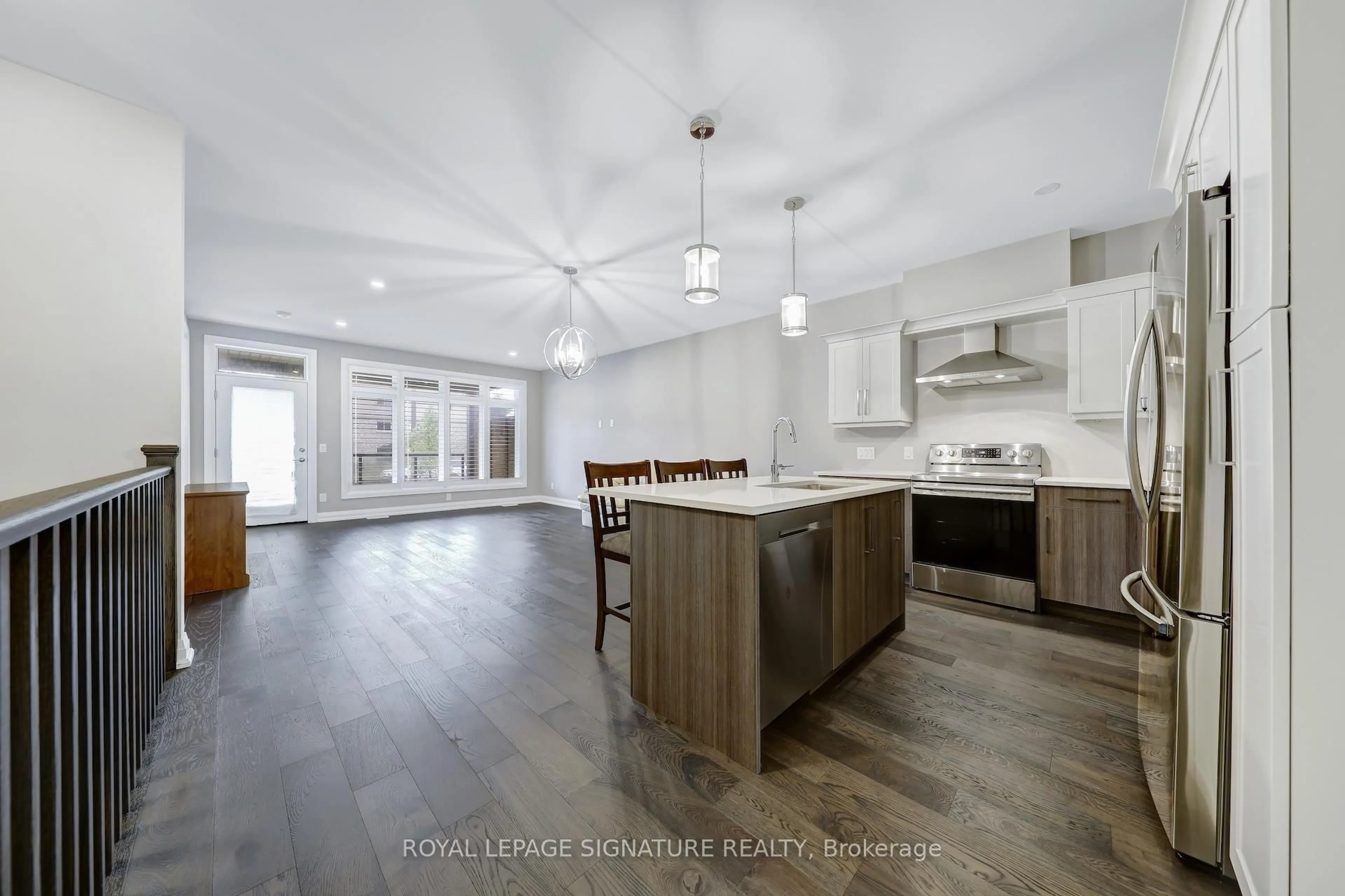 Open concept kitchen, wood/laminate floor for 8974 Willoughby Dr #2, Niagara Falls Ontario L2G 7Y4