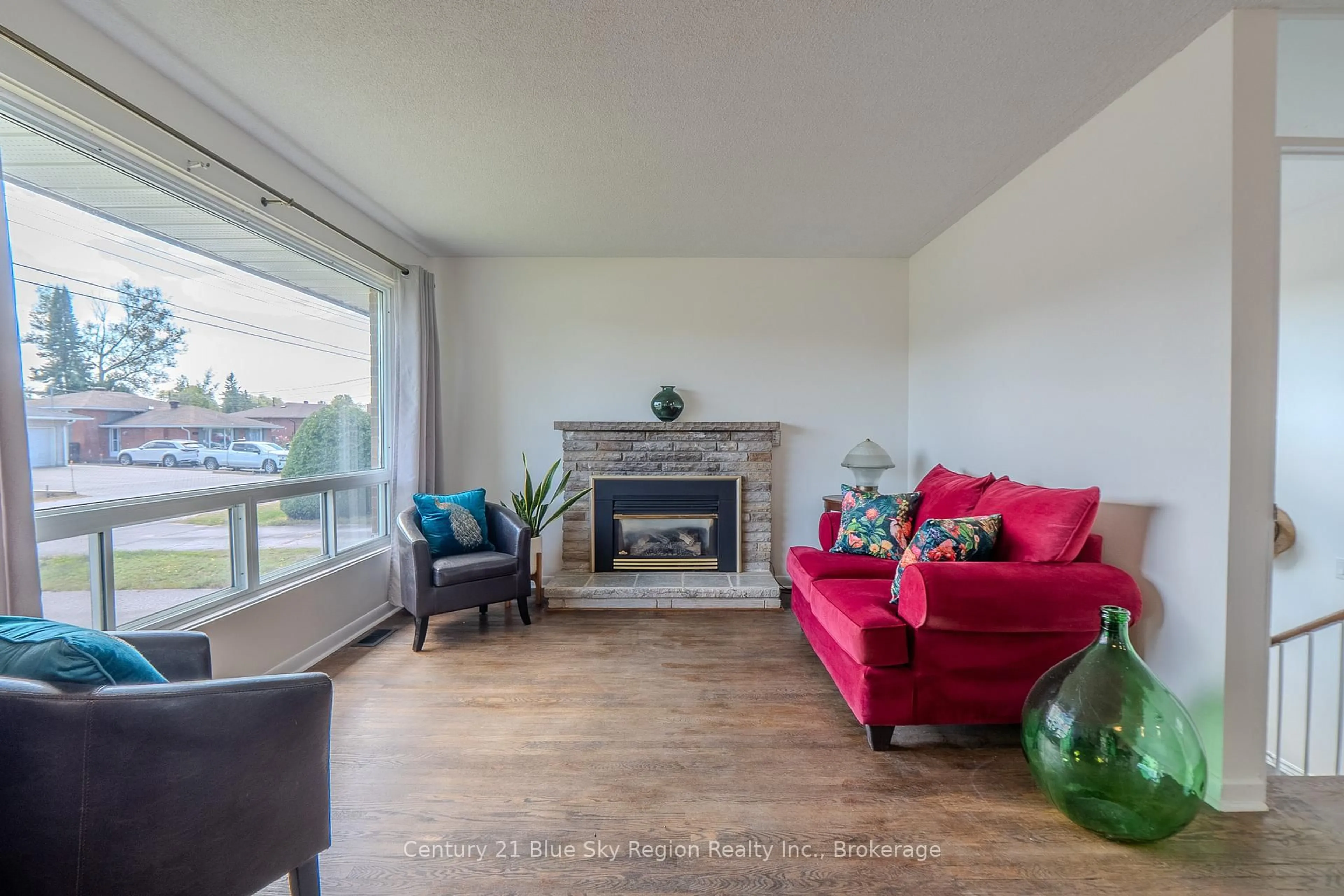Living room with furniture, wood/laminate floor for 62 Strathcona Dr, North Bay Ontario P1A 2N1
