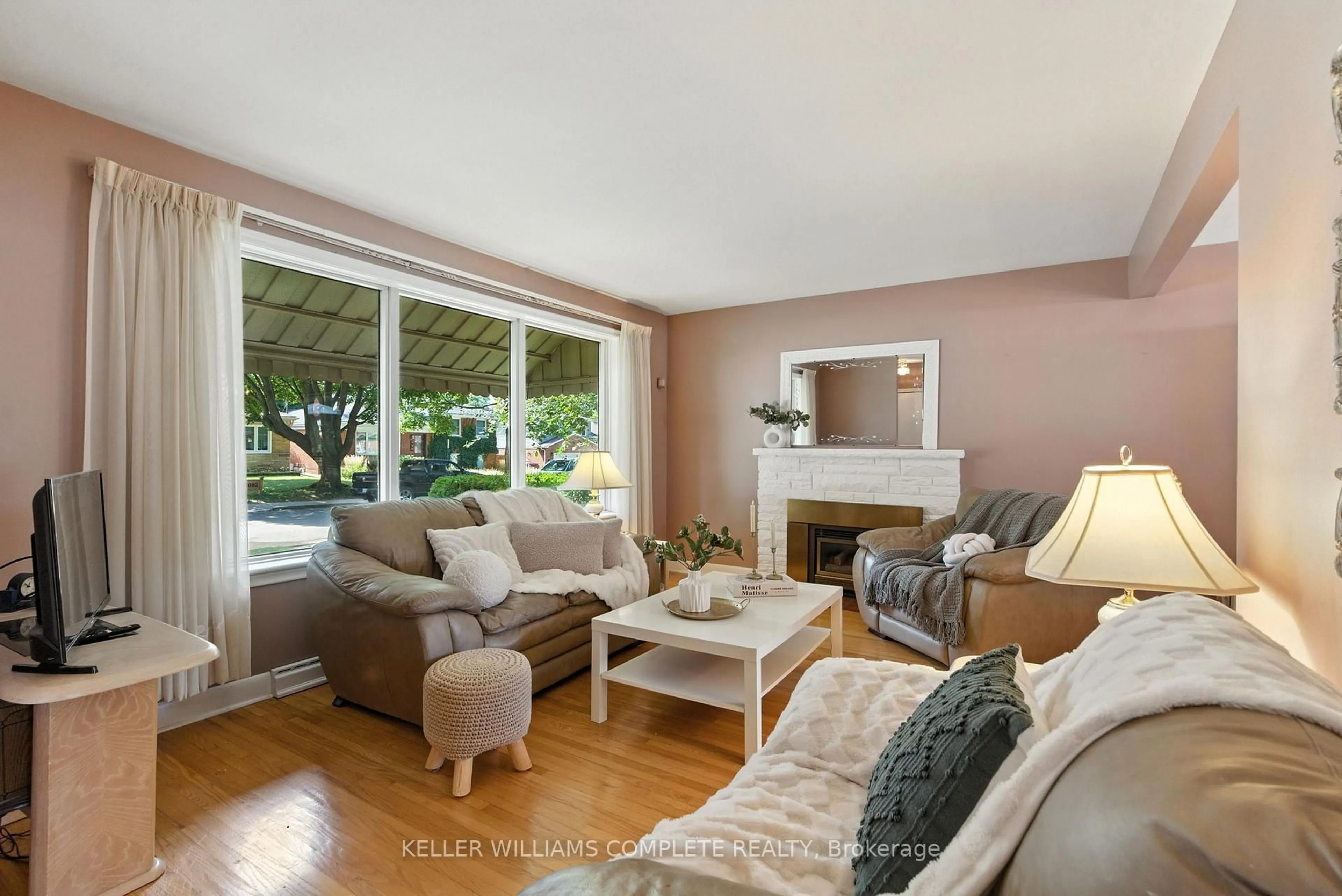 Living room with furniture, wood/laminate floor for 1001 Brucedale Ave, Hamilton Ontario L8T 1M6