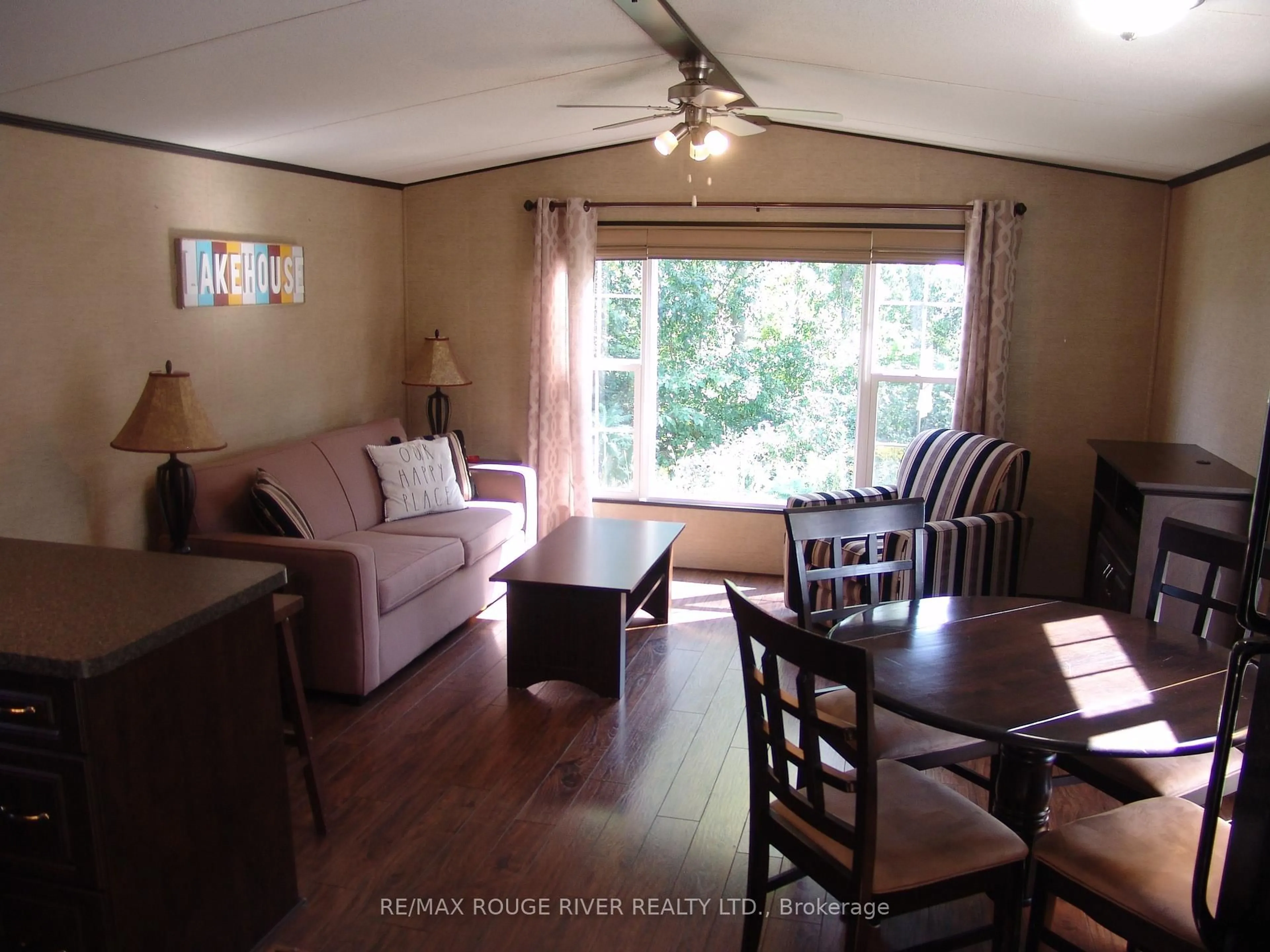 Living room with furniture, wood/laminate floor for 1235 Villiers Line, Otonabee-South Monaghan Ontario K0L 1Y0