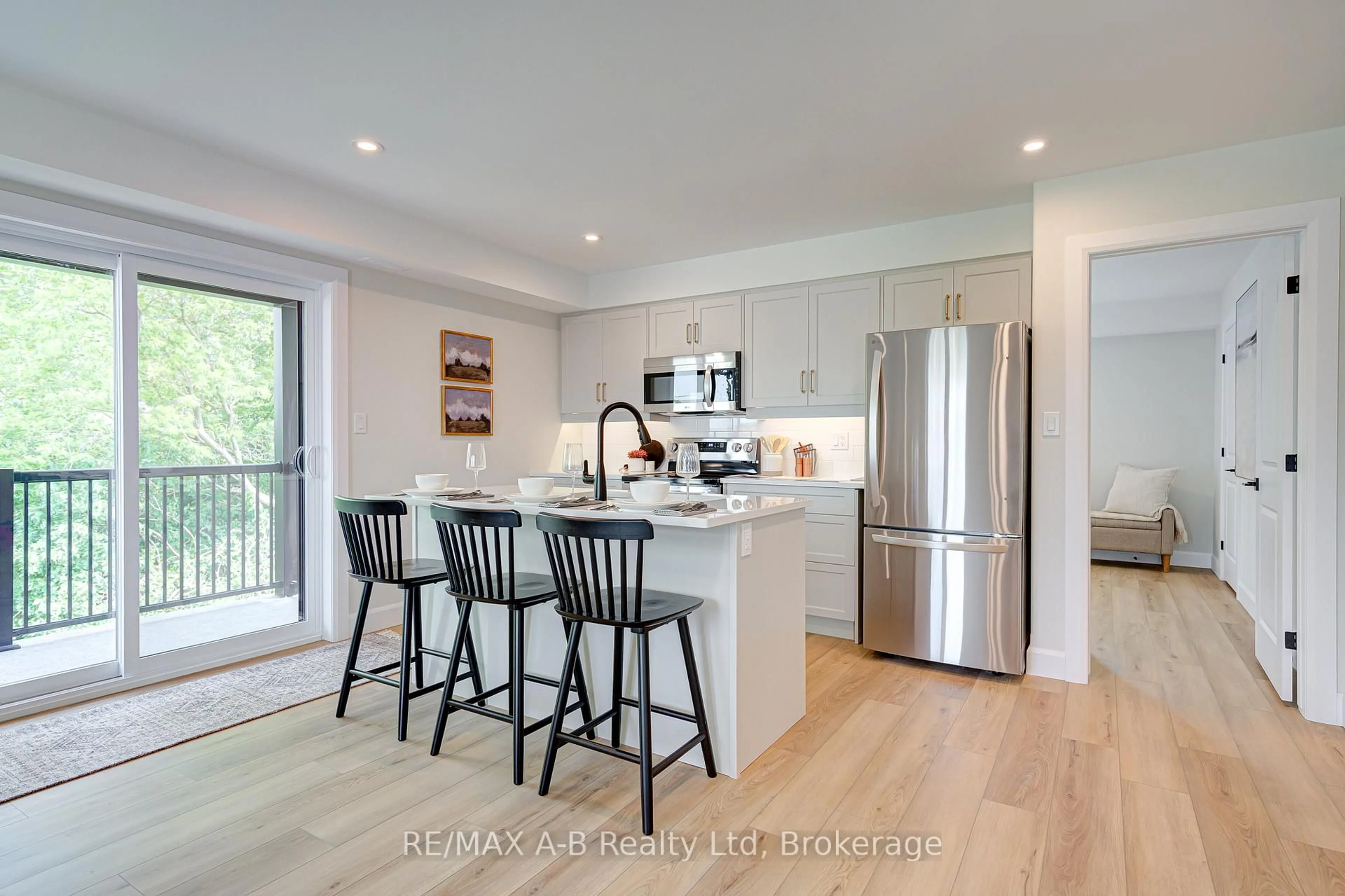 Open concept kitchen, wood/laminate floor for 428 Queen St ##6, St. Marys Ontario N4X 1C4