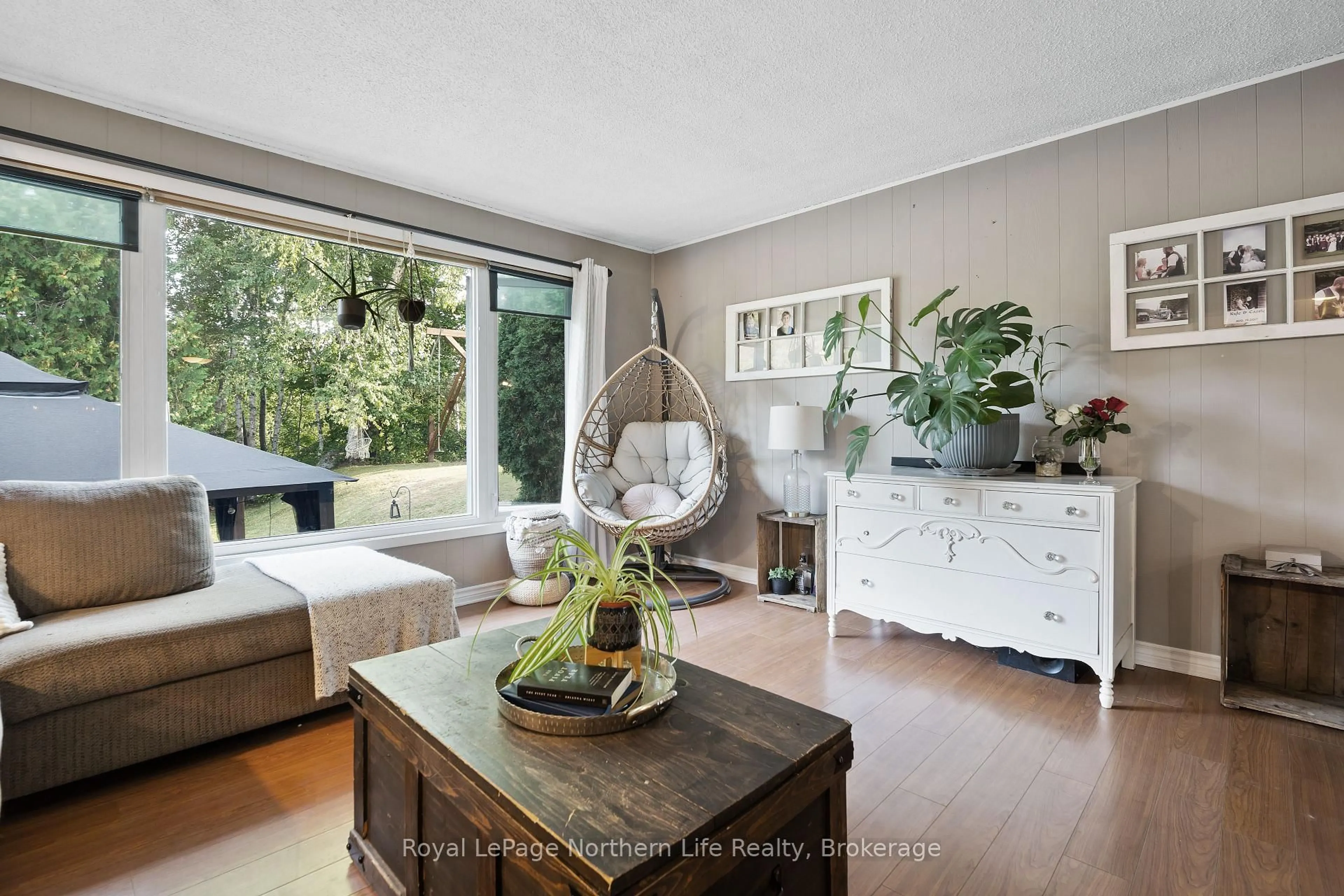 Living room with furniture, wood/laminate floor for 103 Development Rd, Bonfield Ontario P0H 1E0