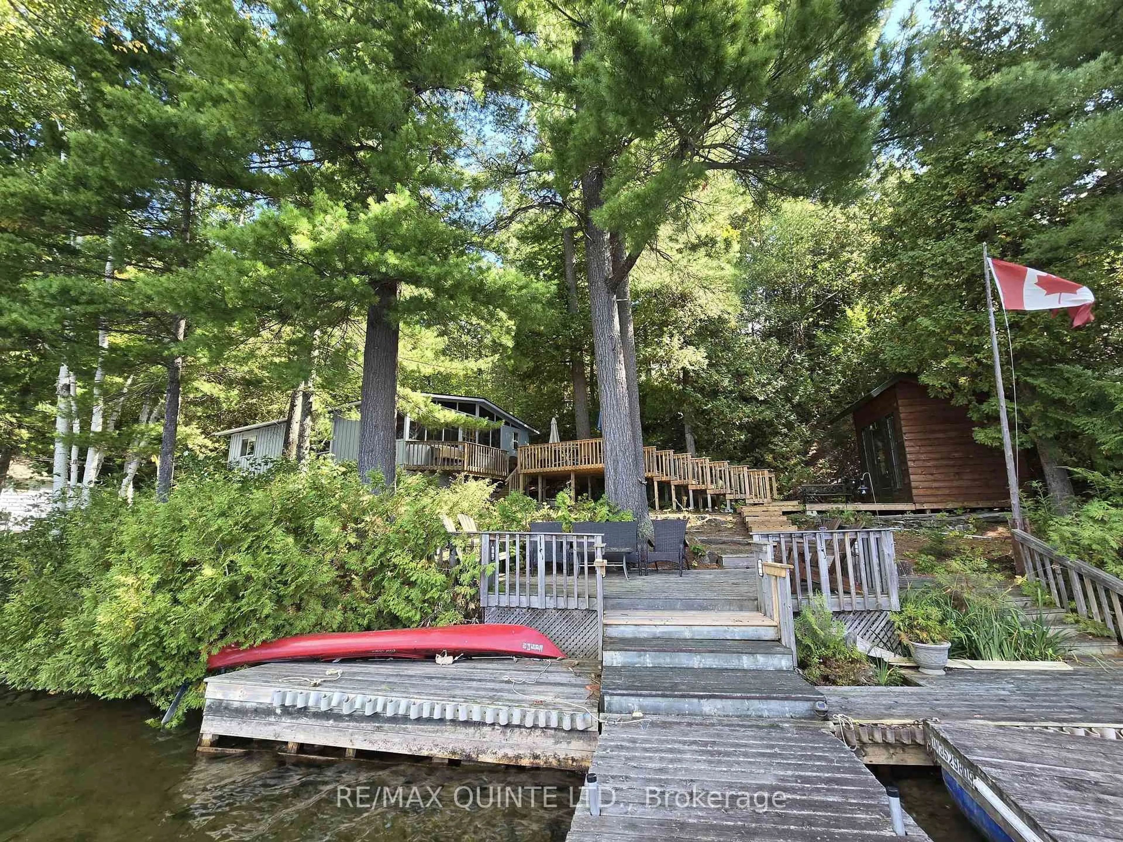 A pic from outside/outdoor area/front of a property/back of a property/a pic from drone, water/lake/river/ocean view for 1261A Shawenegog Lake Lane, Cloyne Ontario K0H 1K0