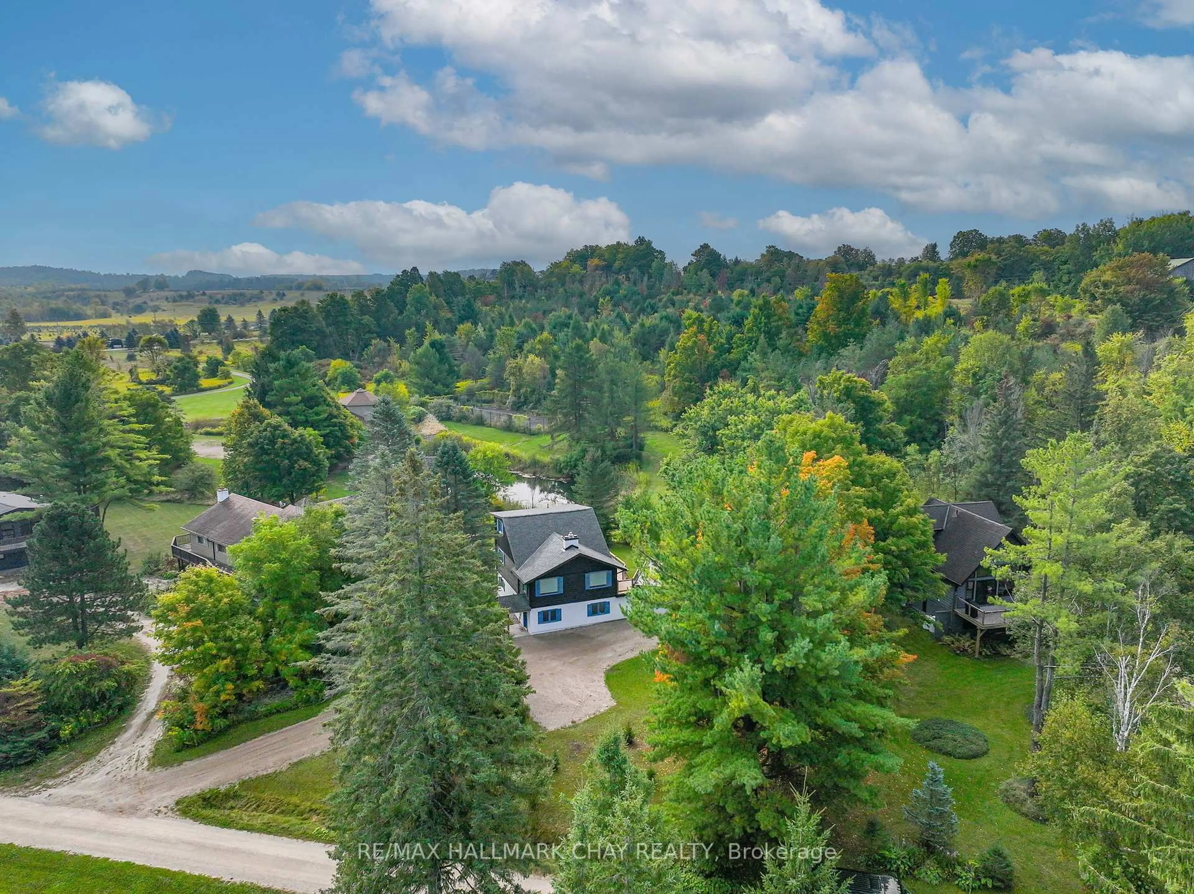 A pic from outside/outdoor area/front of a property/back of a property/a pic from drone, forest/trees view for 61 Pine River Cres, Mulmur Ontario L9V 3H3