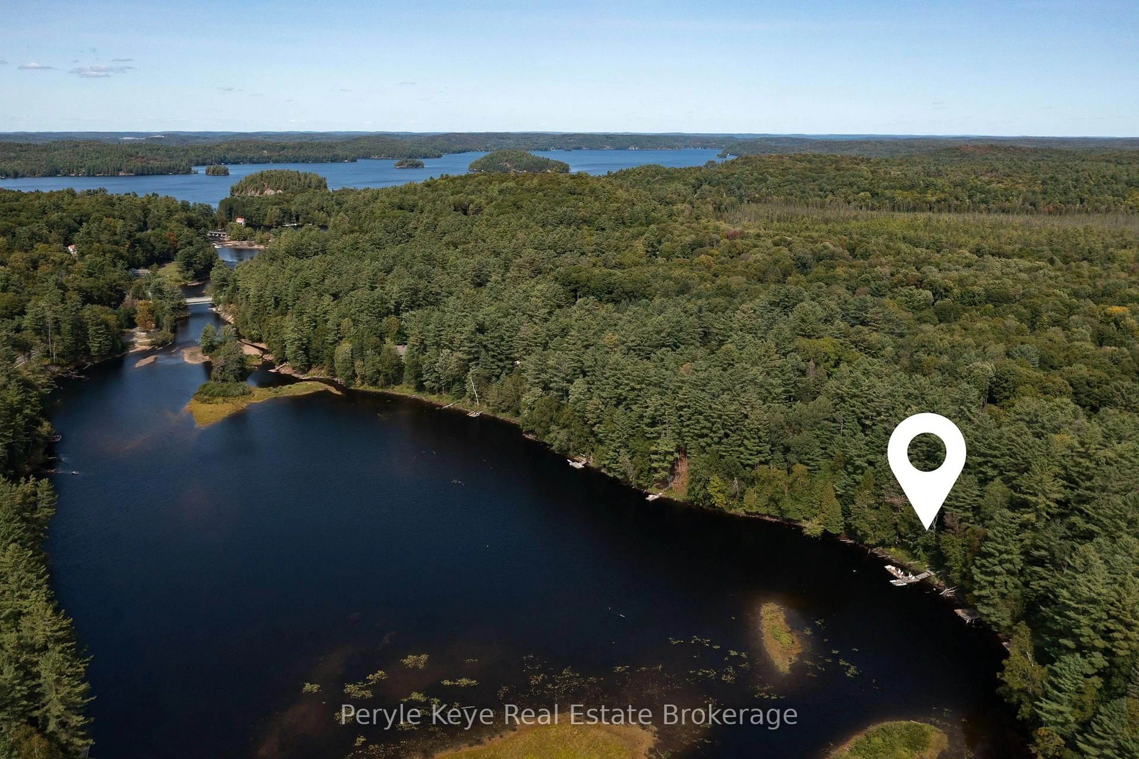 A pic from outside/outdoor area/front of a property/back of a property/a pic from drone, water/lake/river/ocean view for 136 Deer Lake Rd, Huntsville Ontario P0B 1L0