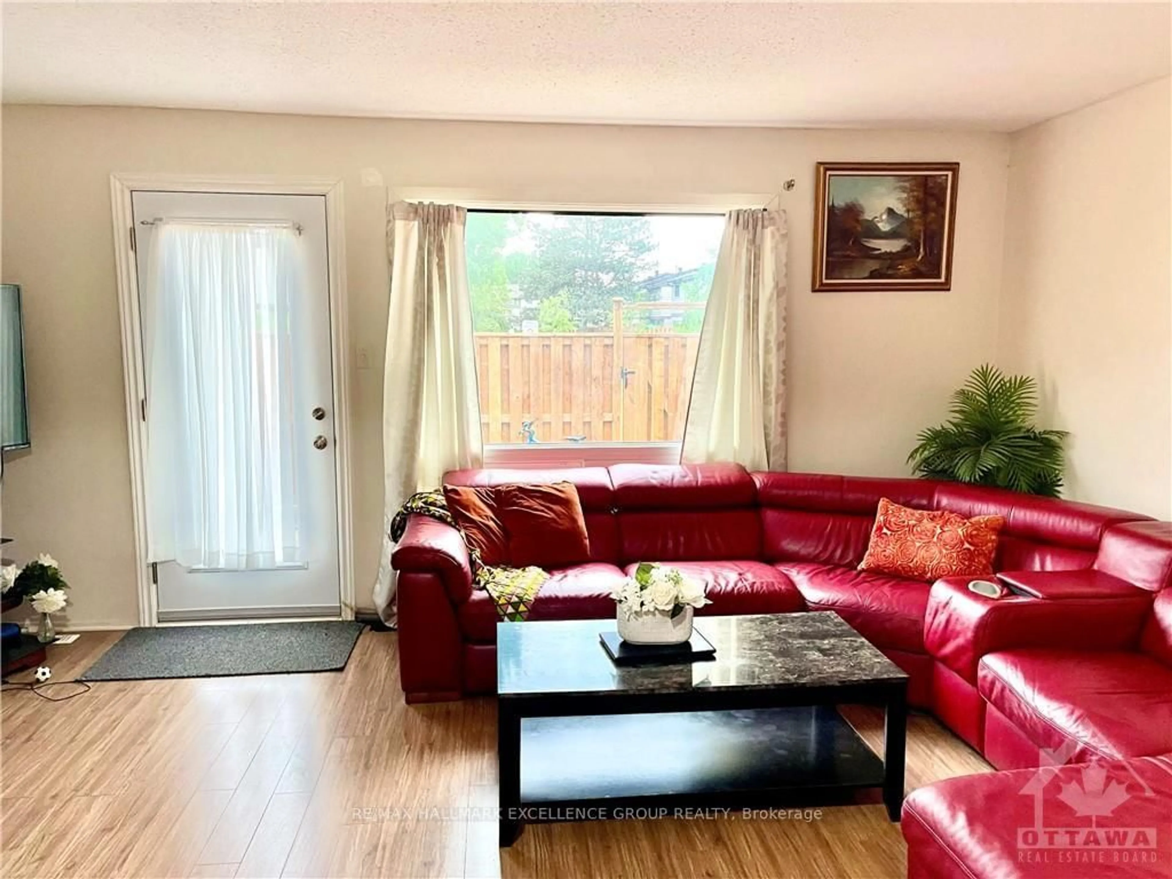 Living room with furniture, wood/laminate floor for 1906 BELMORE Lane #8, Ottawa Ontario K1B 4Z8