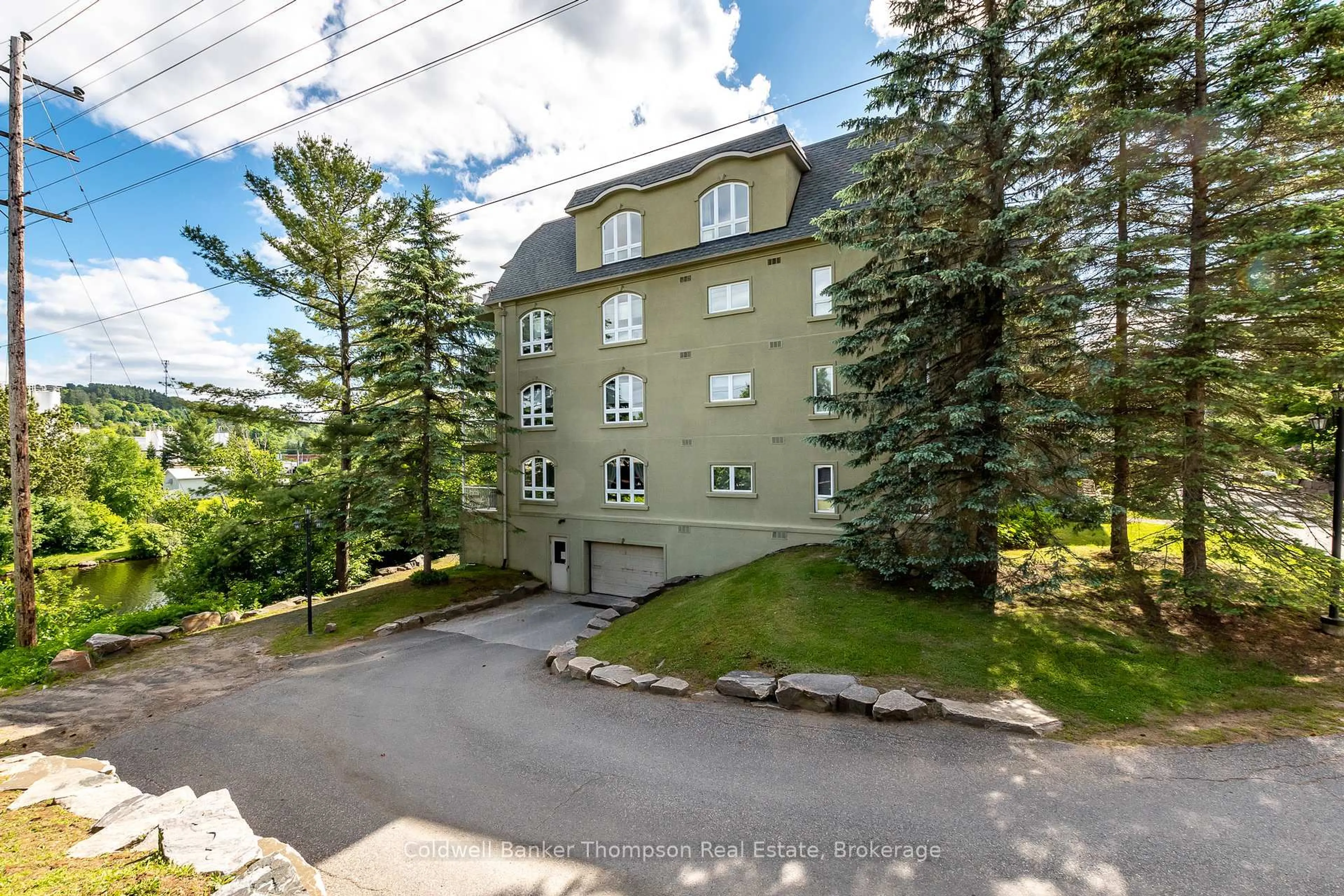A pic from outside/outdoor area/front of a property/back of a property/a pic from drone, unknown for 31 Dairy Lane #203, Huntsville Ontario P1H 2L7