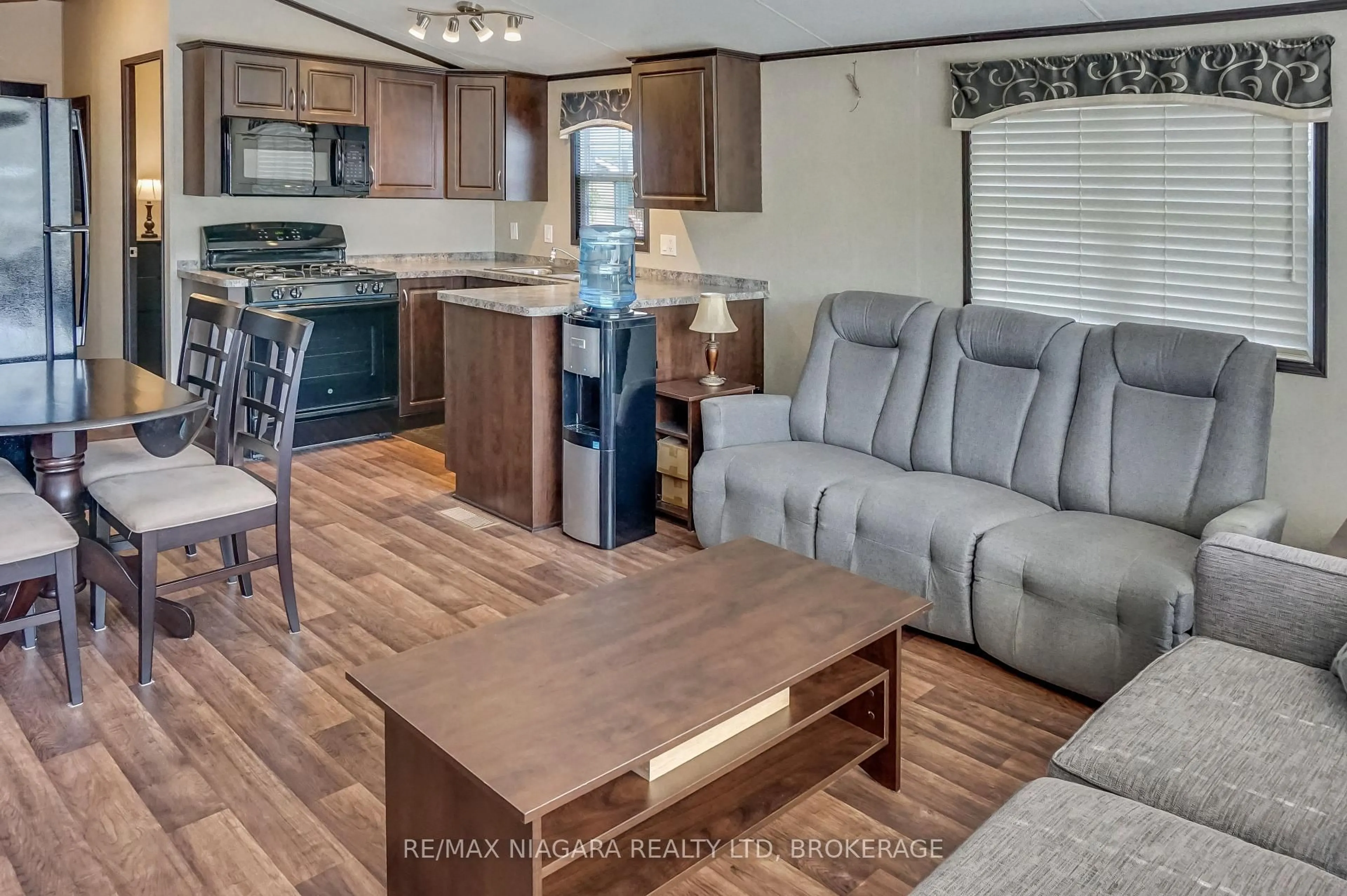 Living room with furniture, wood/laminate floor for 1501 Line 8 Rd #228, Niagara-on-the-Lake Ontario L0S 1L0