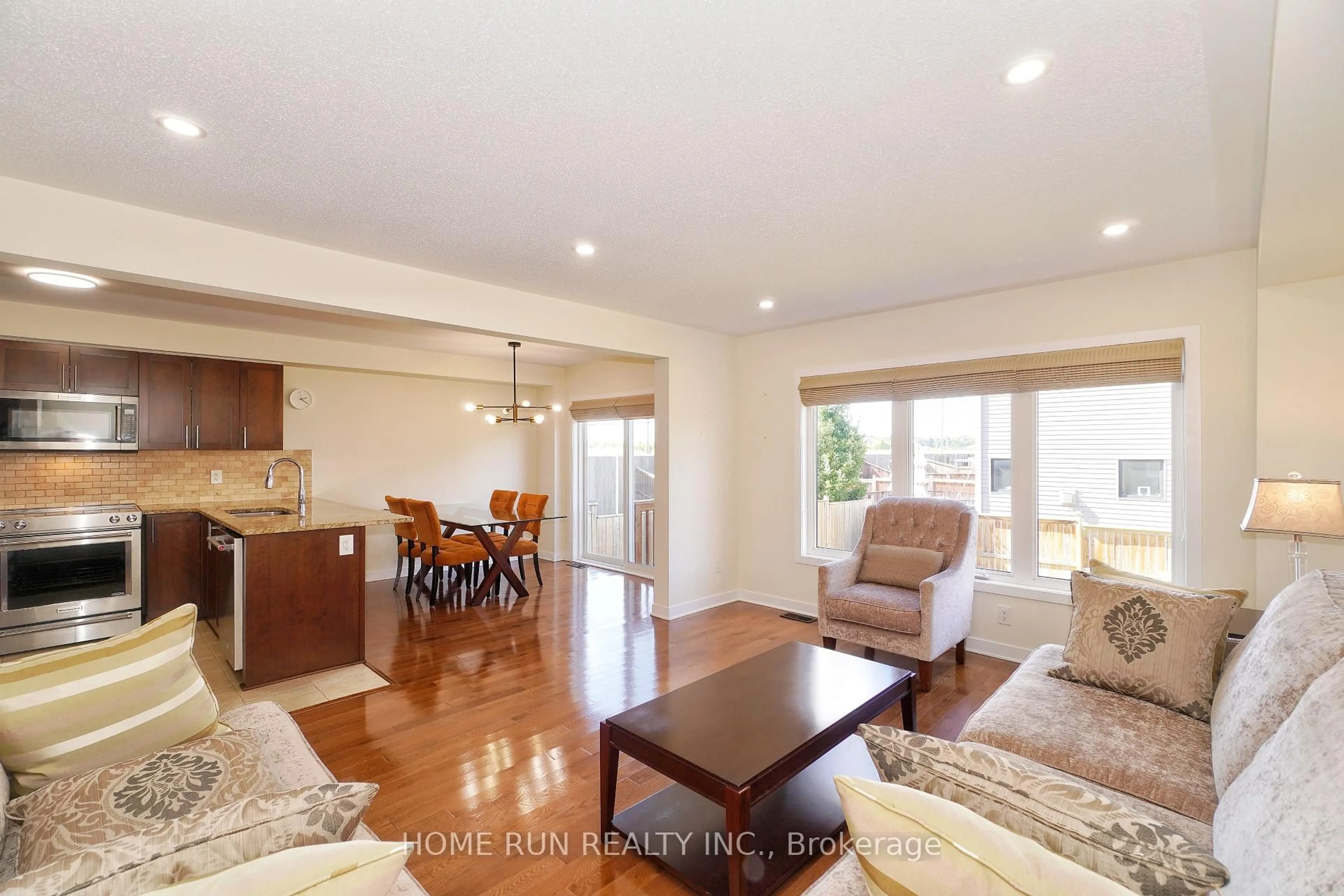 Living room with furniture, wood/laminate floor for 503 Paine Ave, Ottawa Ontario K2T 0K7