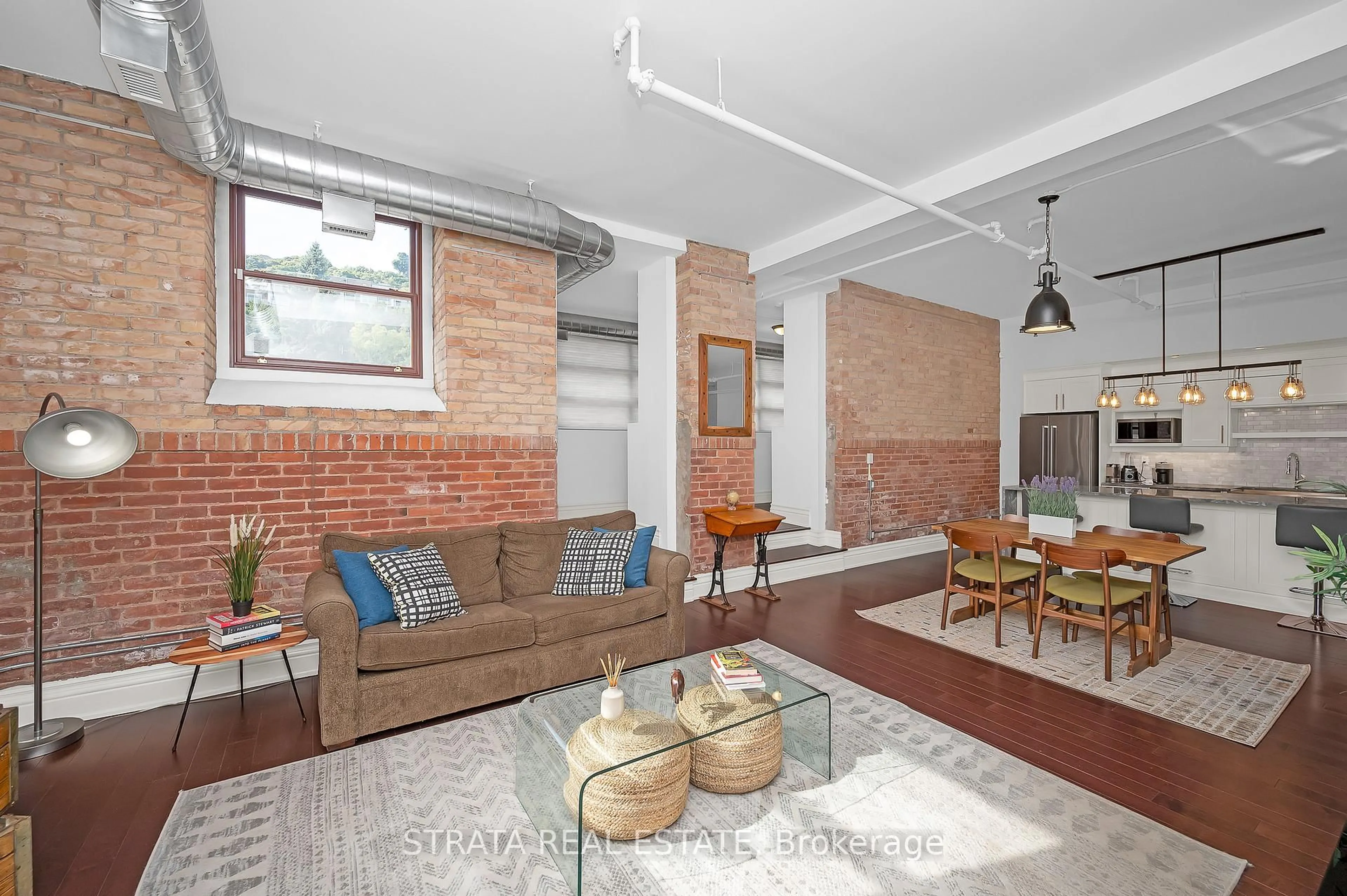 Living room with furniture, cement floor for 200 Stinson St #107, Hamilton Ontario L8N 4J5