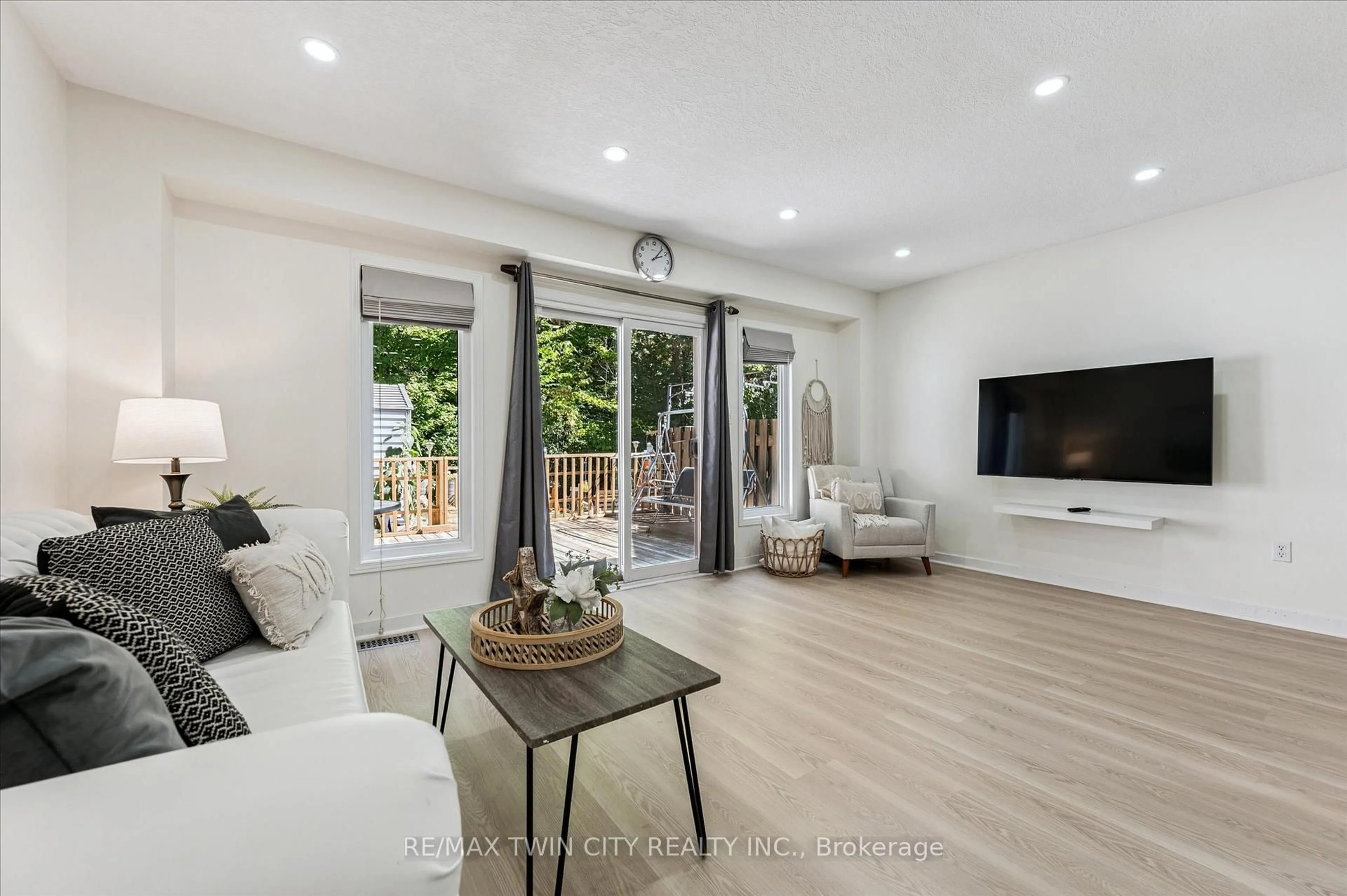 Living room with furniture, wood/laminate floor for 110 Activa Ave, Kitchener Ontario N2E 3T3