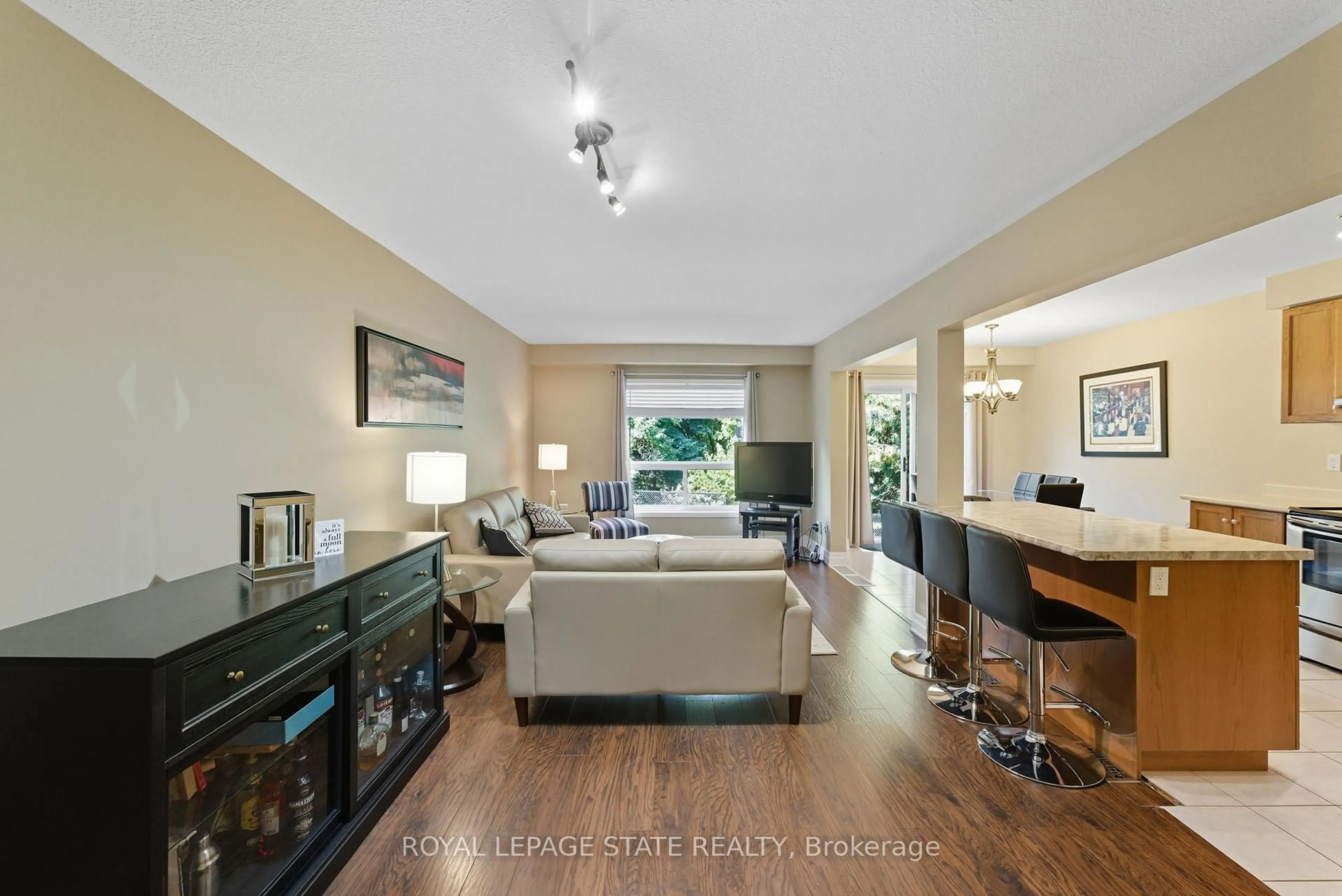 Living room with furniture, wood/laminate floor for 27 Glenhollow Dr, Hamilton Ontario L8J 3T2