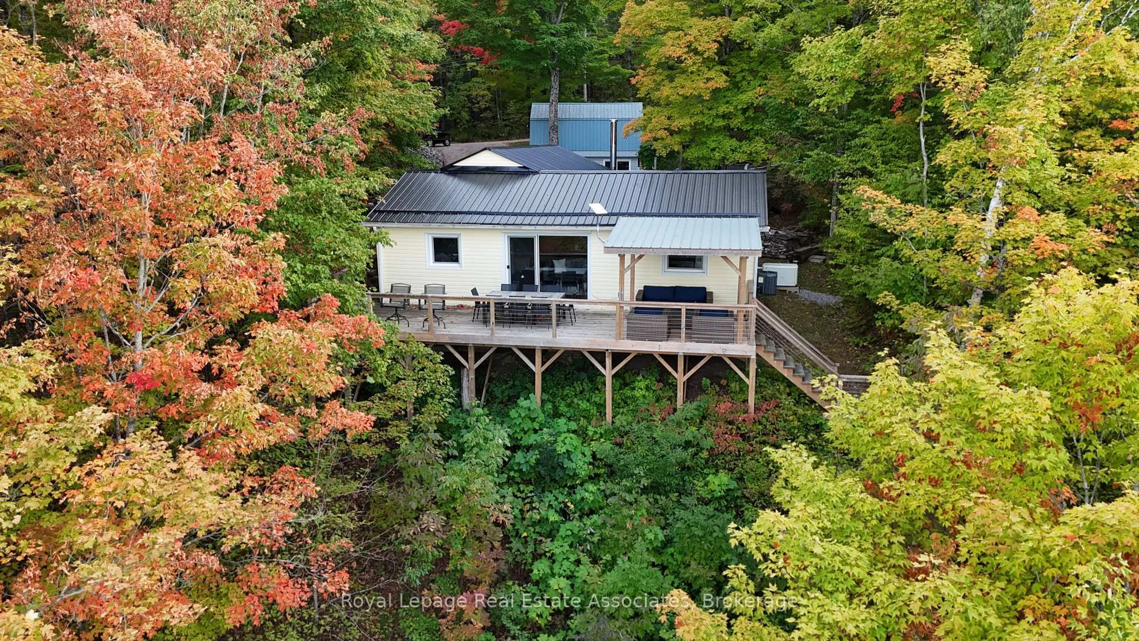 A pic from outside/outdoor area/front of a property/back of a property/a pic from drone, water/lake/river/ocean view for 398 Gilbert Bay Lane, Coe Hill Ontario K0L 1P0