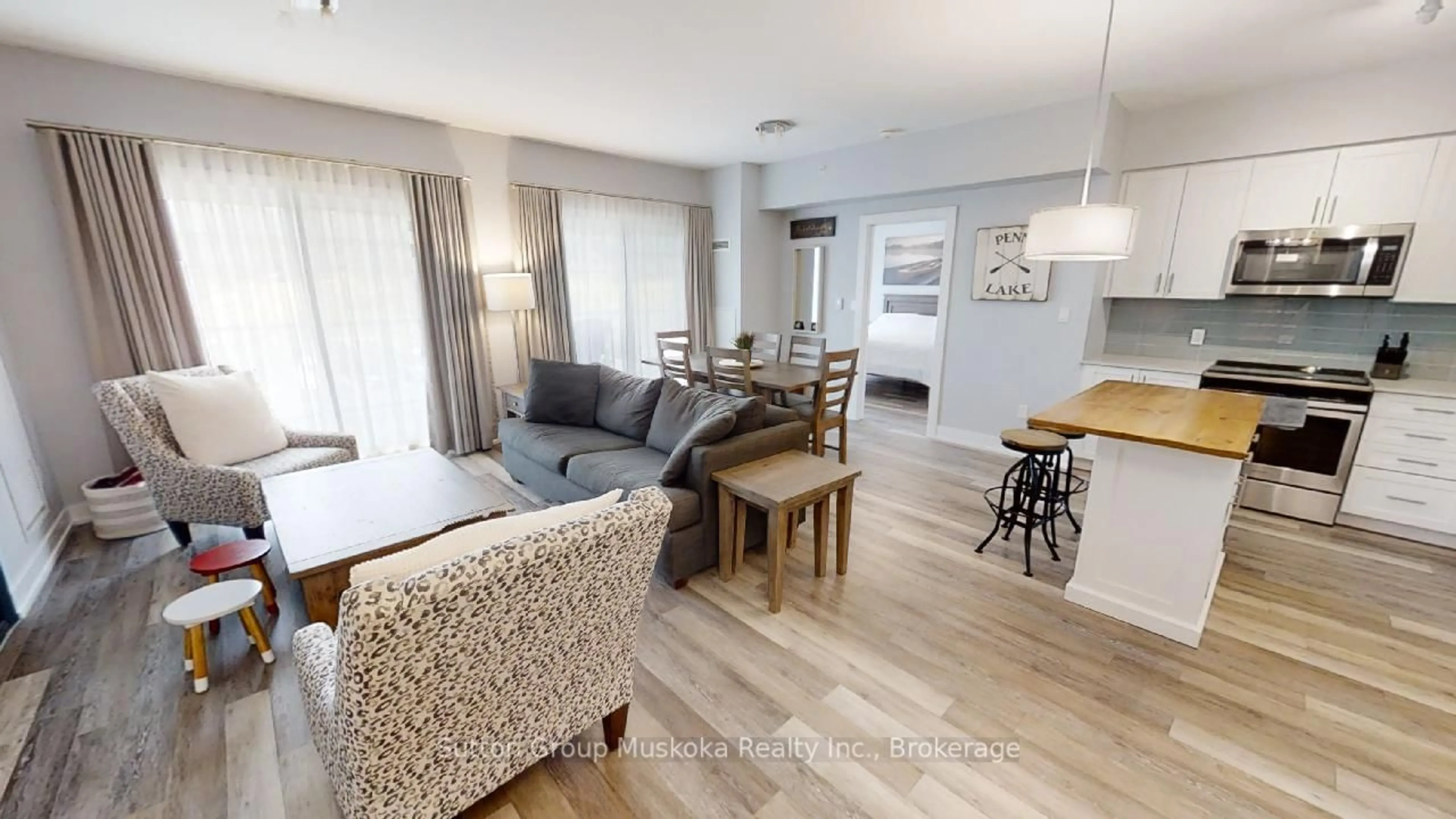 Living room with furniture, wood/laminate floor for 25 Pen Lake Point Rd #318, Huntsville Ontario P1H 2E8