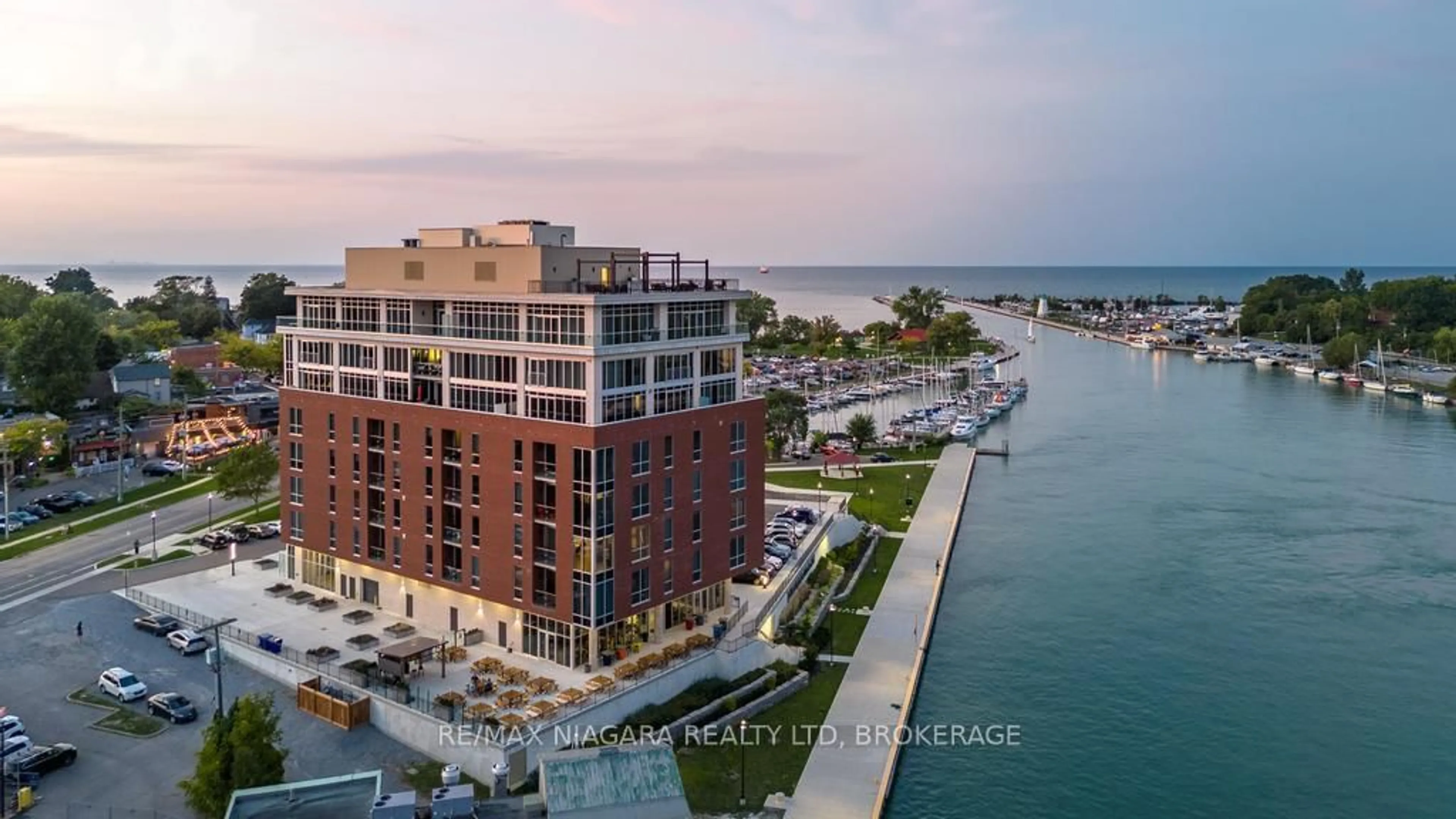 A pic from outside/outdoor area/front of a property/back of a property/a pic from drone, water/lake/river/ocean view for 57 Lakeport Rd #302, St. Catharines Ontario L2N 4P6