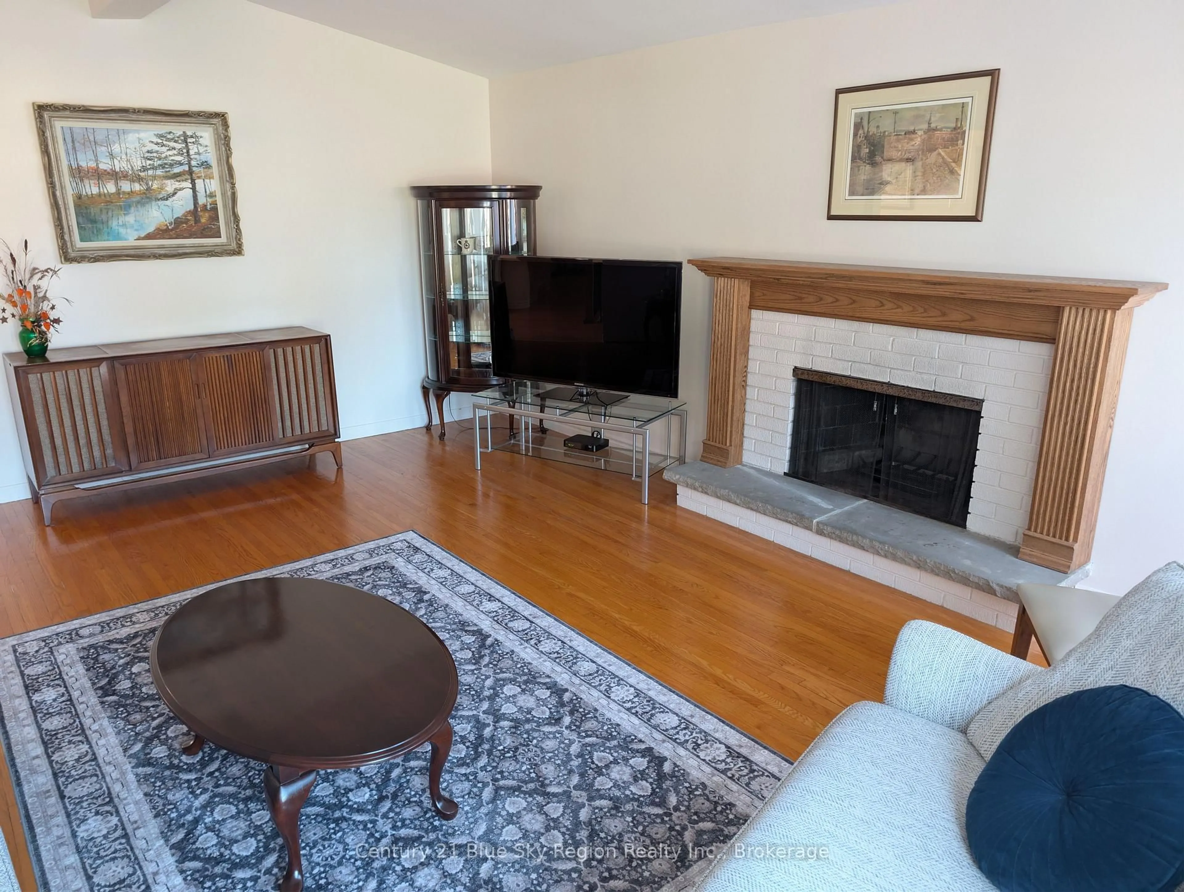 Living room with furniture, wood/laminate floor for 734 Birchwood Rd, North Bay Ontario P1B 4T6