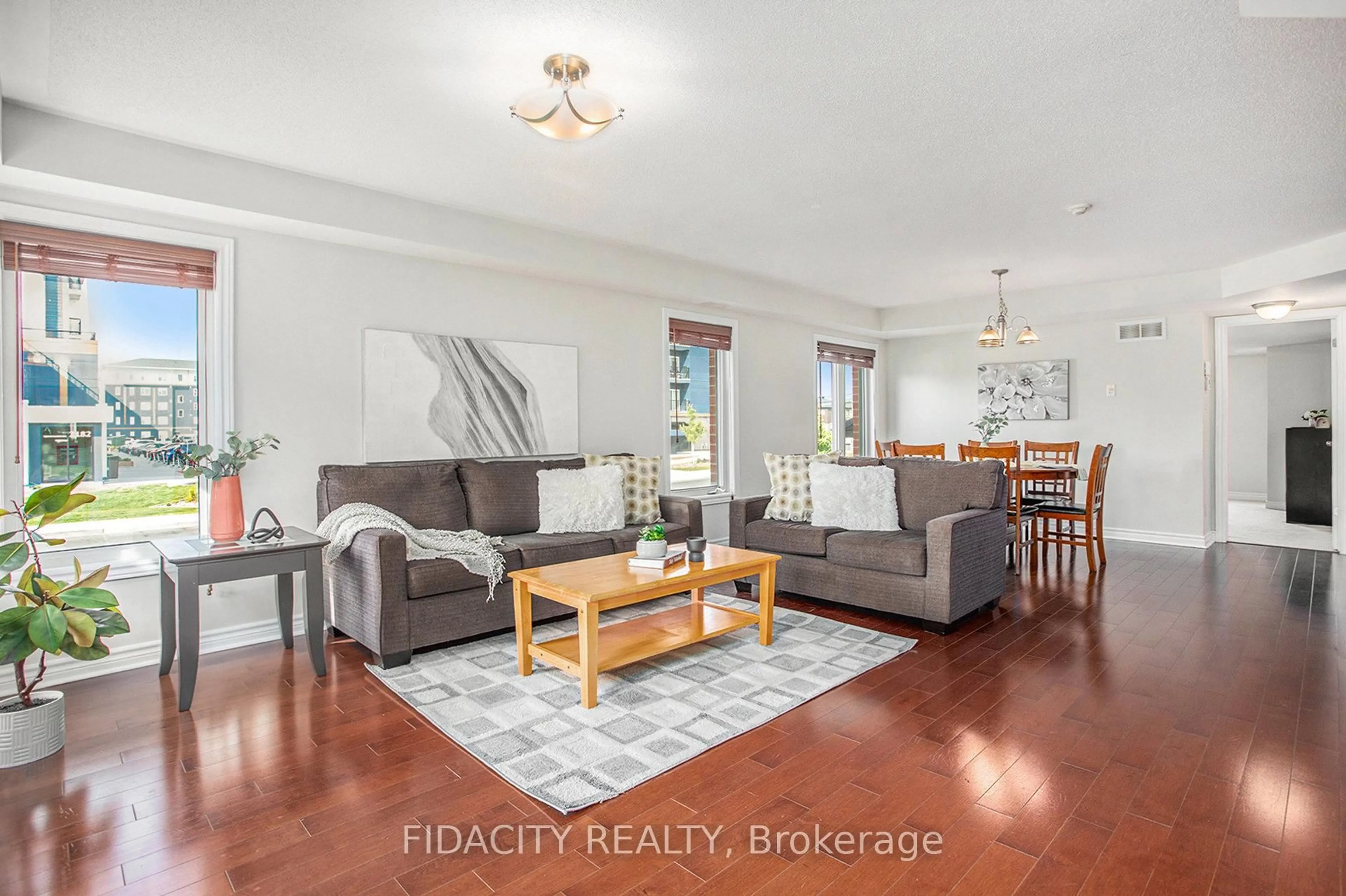 Living room with furniture, wood/laminate floor for 215 Bluestone Private #4, Ottawa Ontario K4A 0X7
