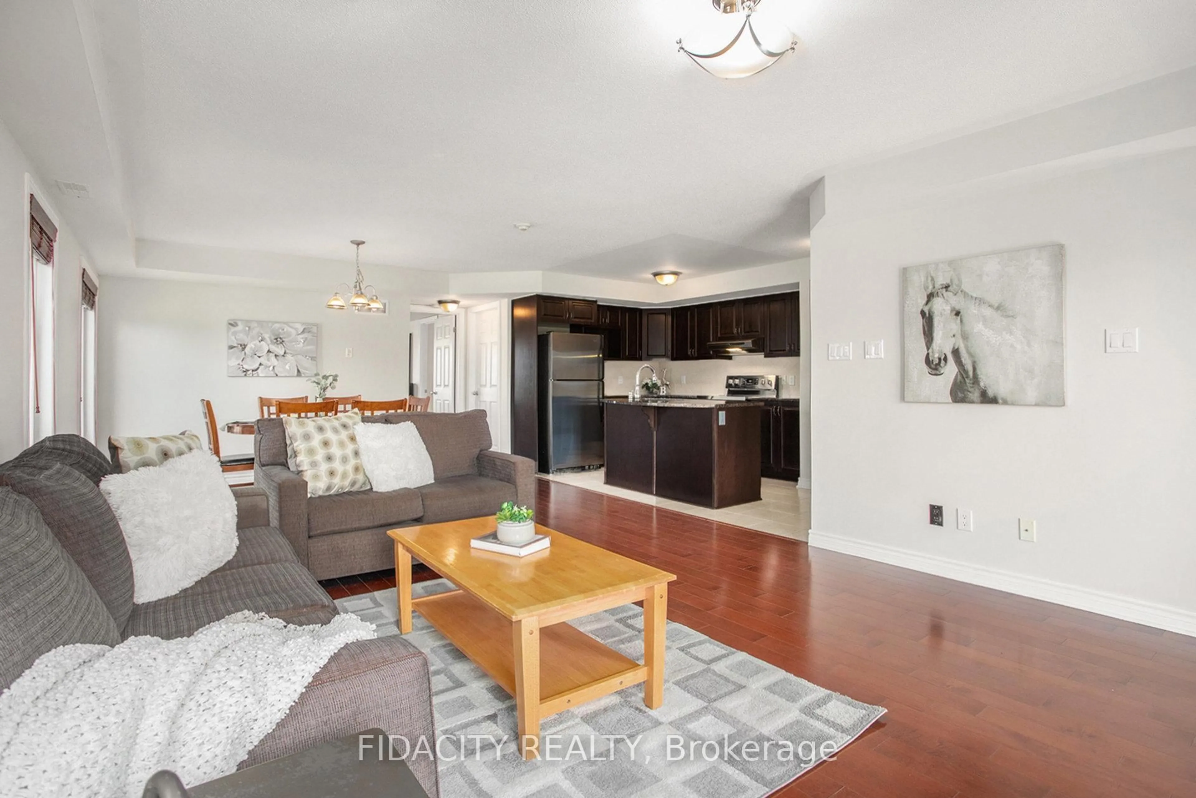 Living room with furniture, wood/laminate floor for 215 Bluestone Private #4, Ottawa Ontario K4A 0X7