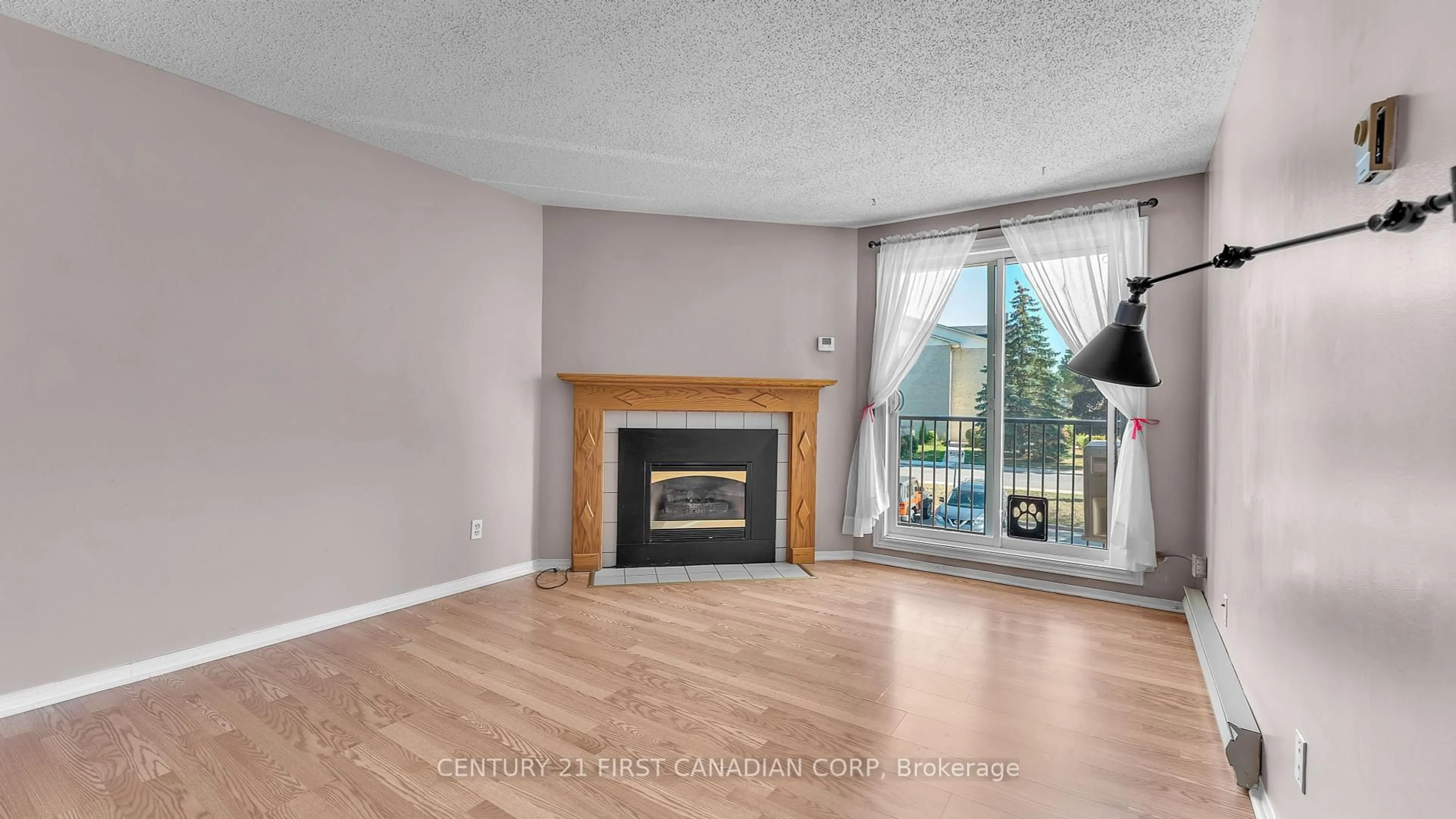 Living room with furniture, wood/laminate floor for 739 Deveron Cres #203, London South Ontario N5Z 4Y1