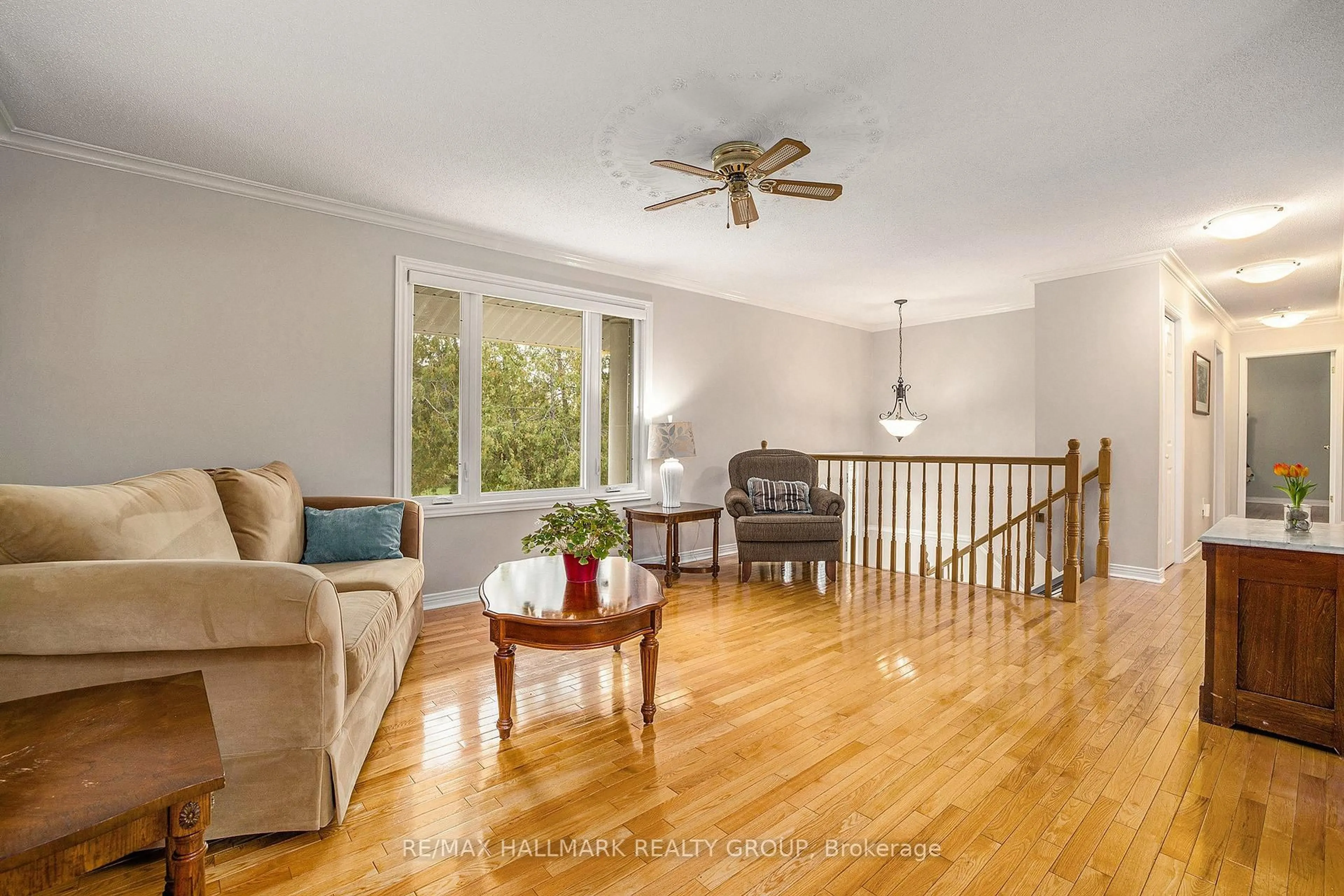Living room with furniture, wood/laminate floor for 115 Delaney Dr, Carp Ontario K0A 1L0