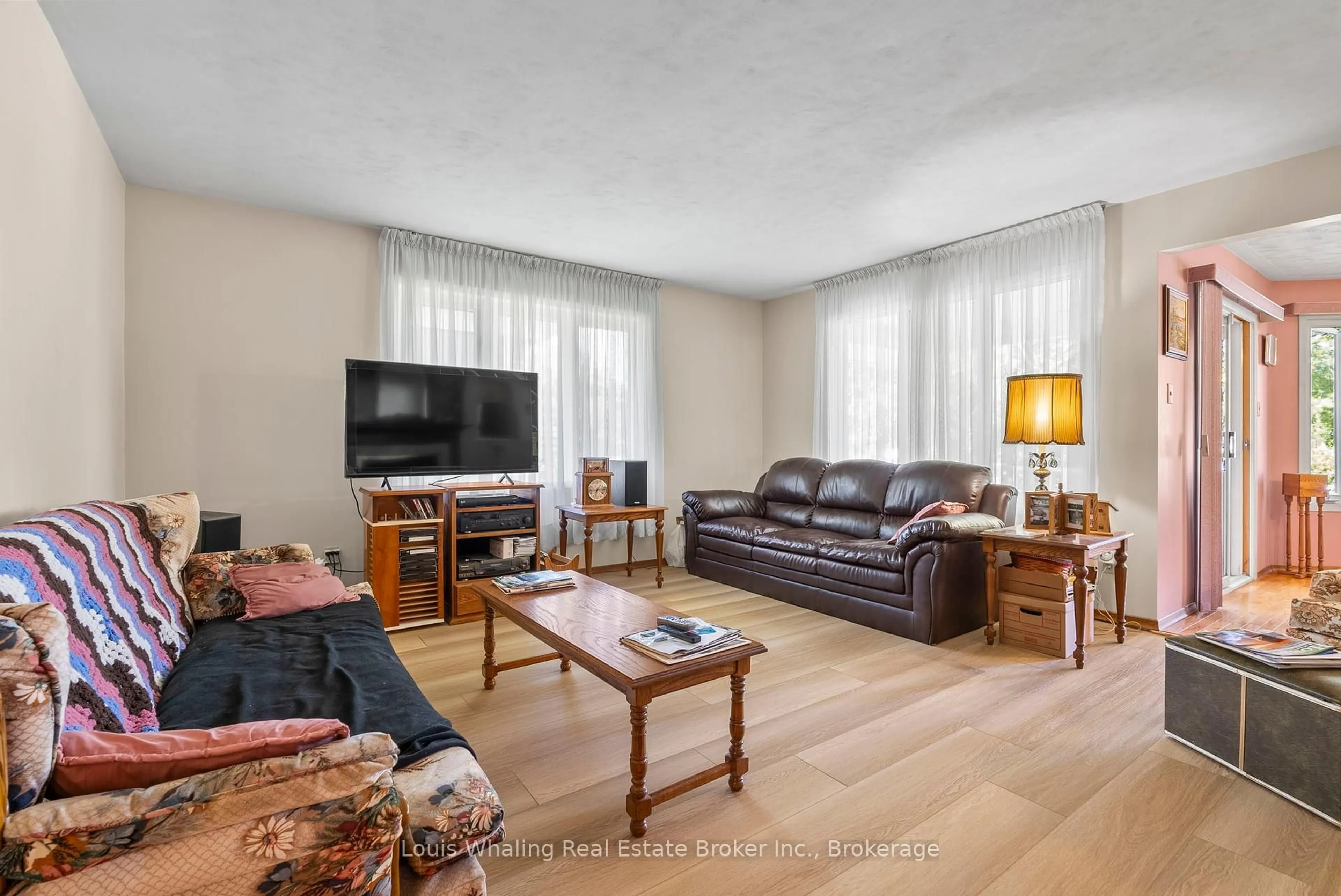 Living room with furniture, wood/laminate floor for 61 8th St, Hanover Ontario N4N 1J1