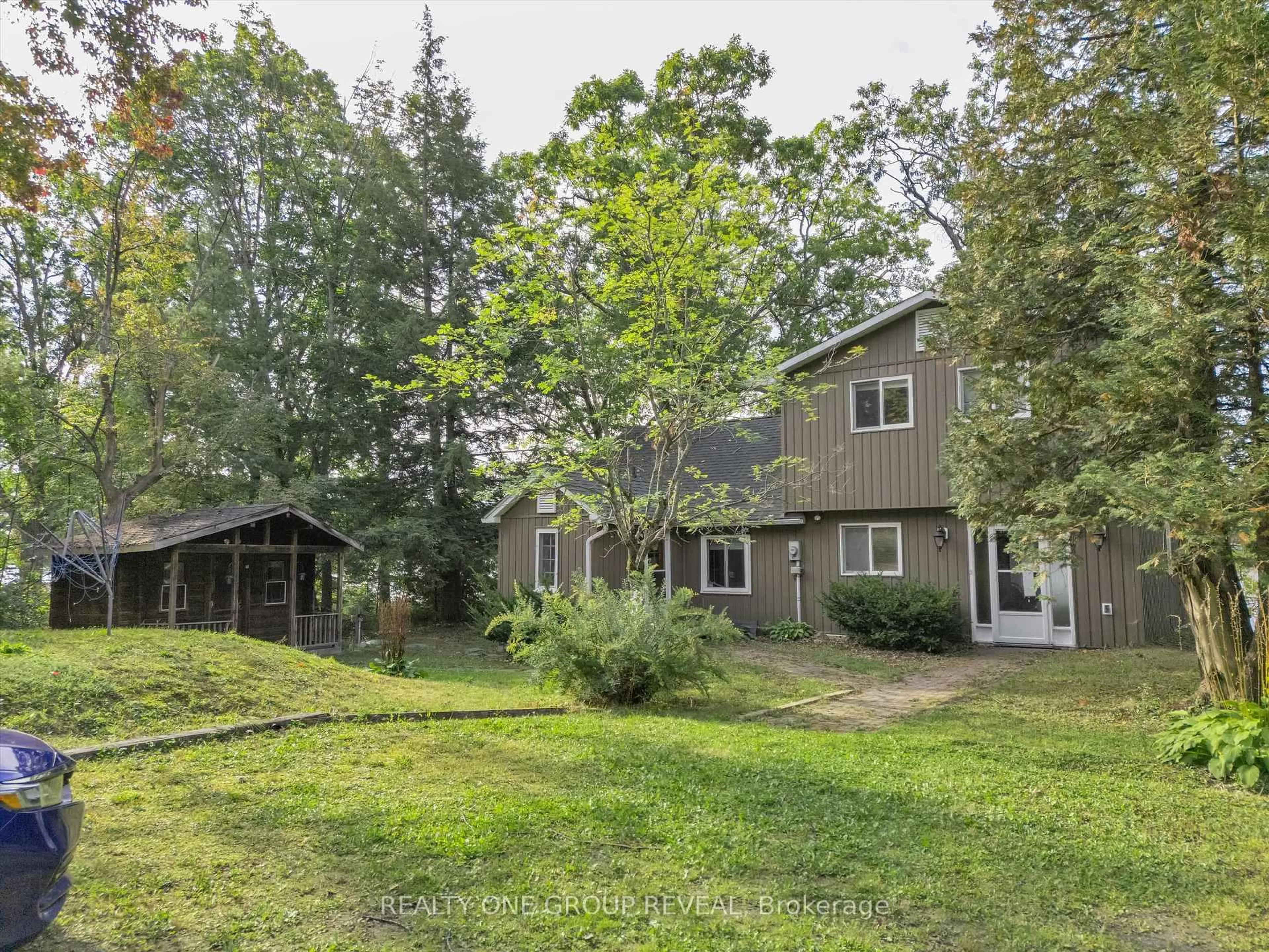 A pic from outside/outdoor area/front of a property/back of a property/a pic from drone, forest/trees view for 1067 River St #2, Muskoka Lakes Ontario L1L 0T1