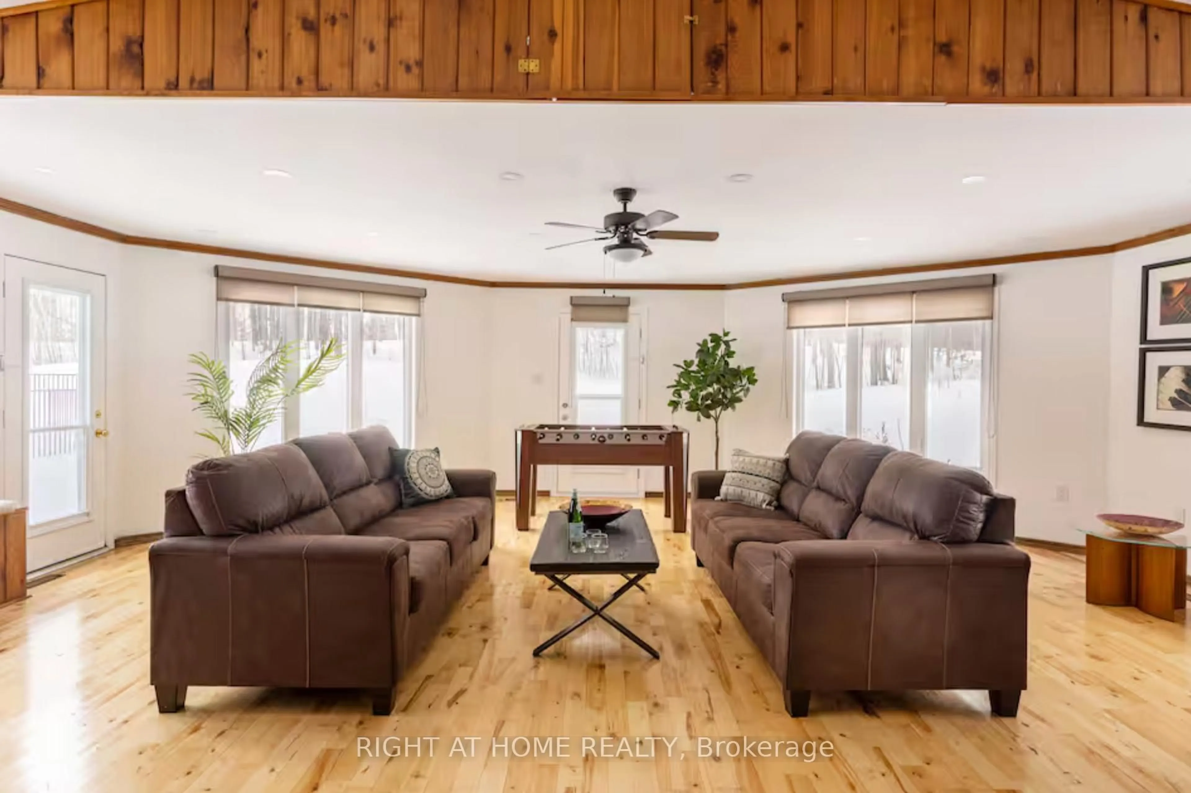 Living room with furniture, wood/laminate floor for 938335 Airport Rd, Mulmur Ontario L0N 1M0