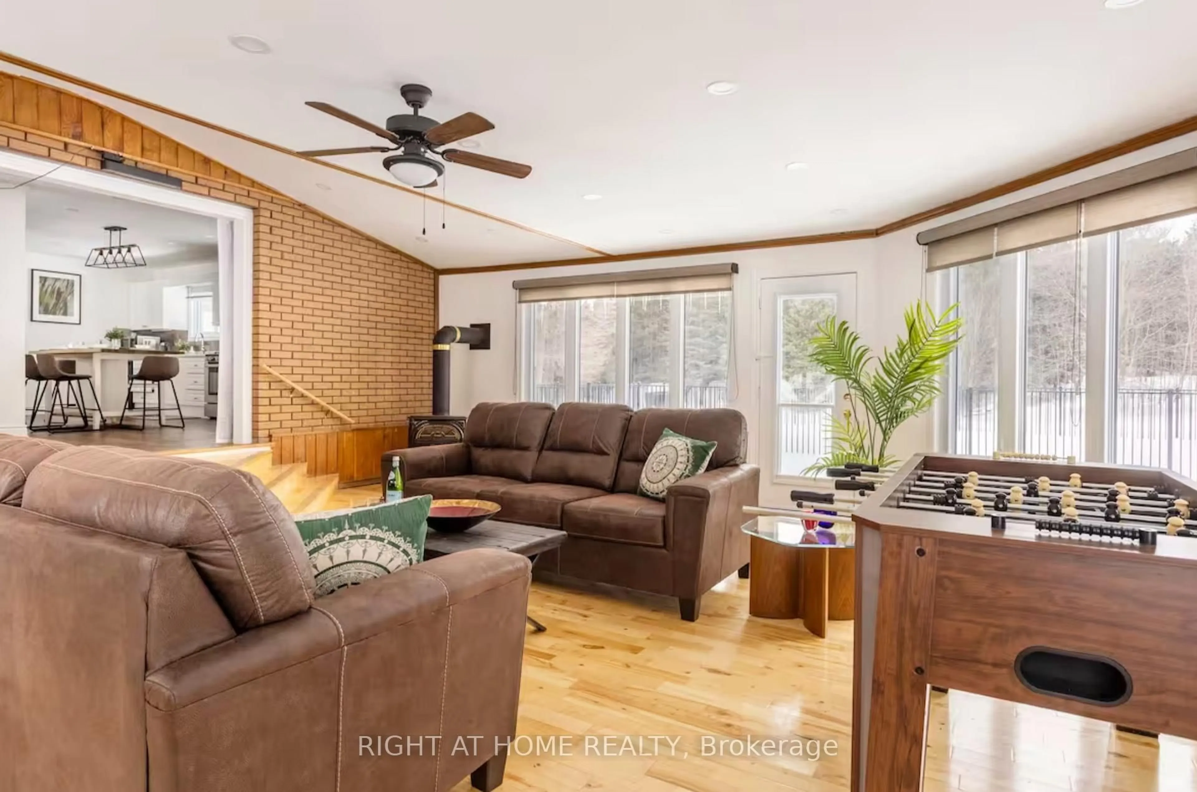 Living room with furniture, wood/laminate floor for 938335 Airport Rd, Mulmur Ontario L0N 1M0