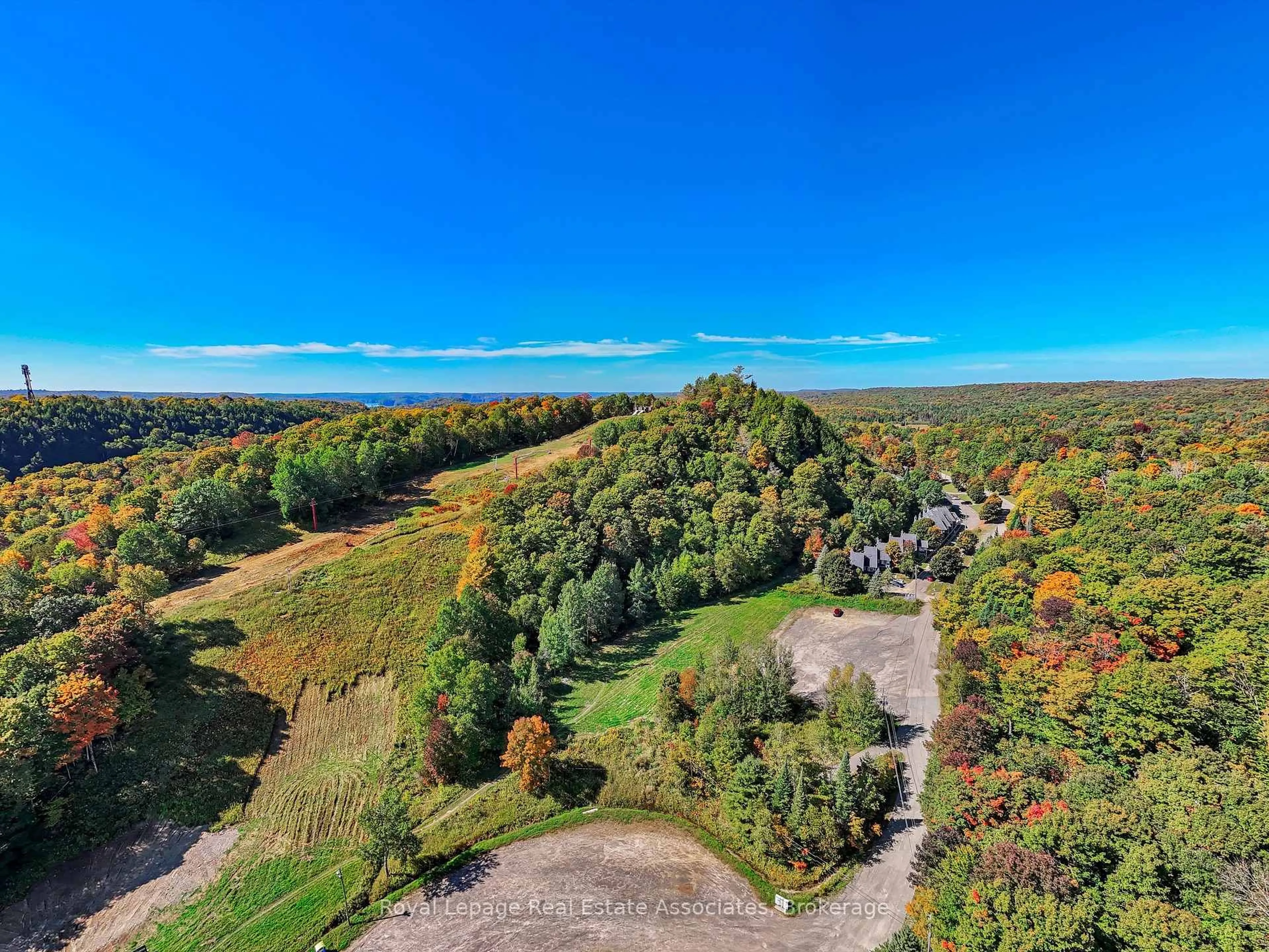 A pic from outside/outdoor area/front of a property/back of a property/a pic from drone, forest/trees view for 1581 Hidden Valley Rd #16, Huntsville Ontario P1H 1A4