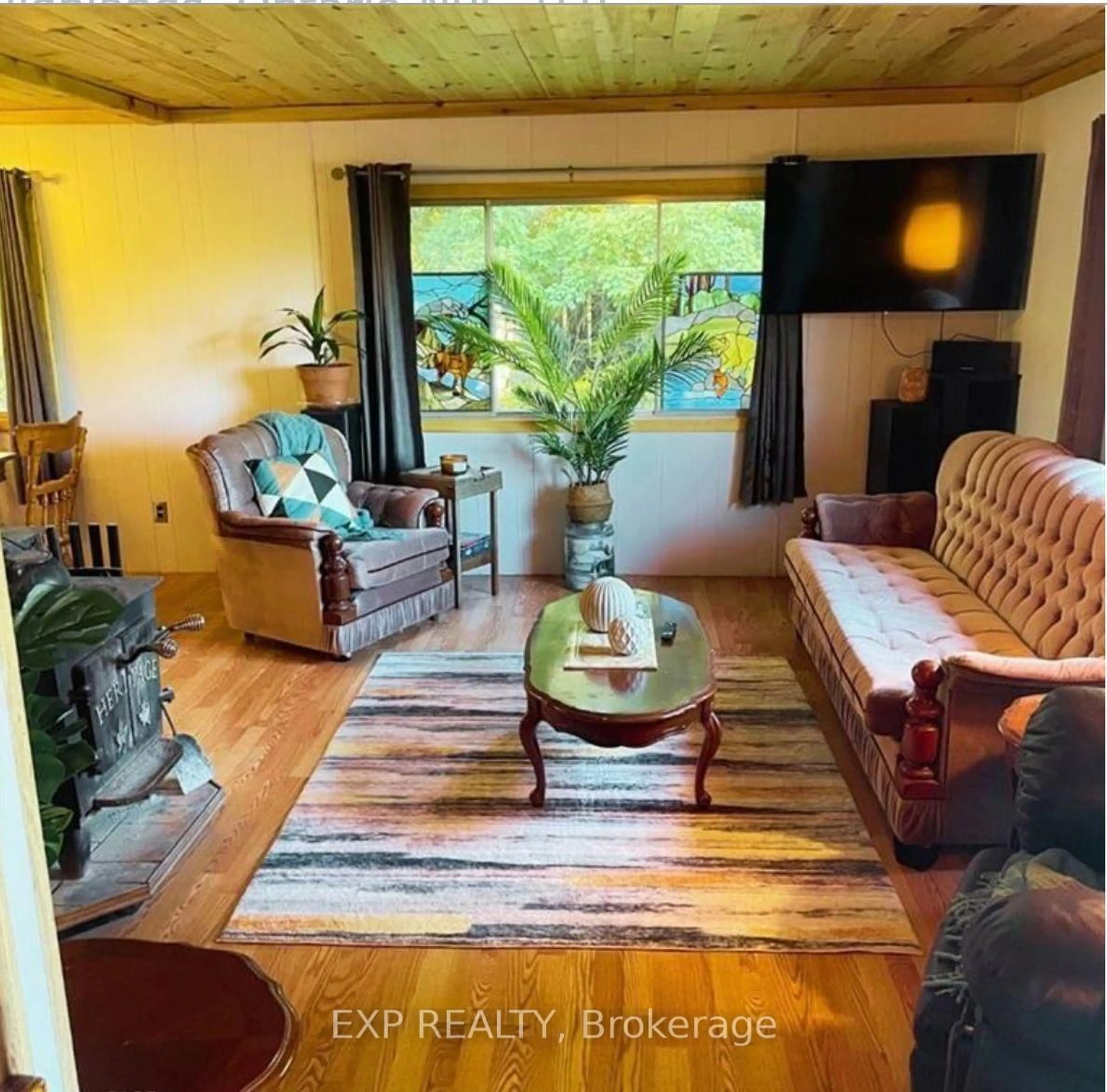 Living room with furniture, wood/laminate floor for 813016 East Back Line, Grey Highlands Ontario N0C 1L0