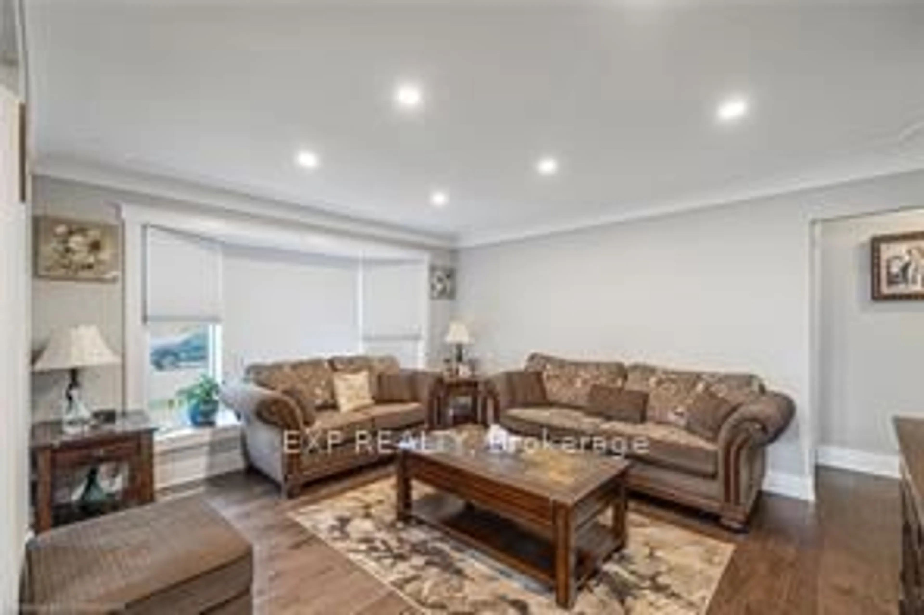Living room with furniture, wood/laminate floor for 1057 Clare Ave, Cambridge Ontario N3H 2E2