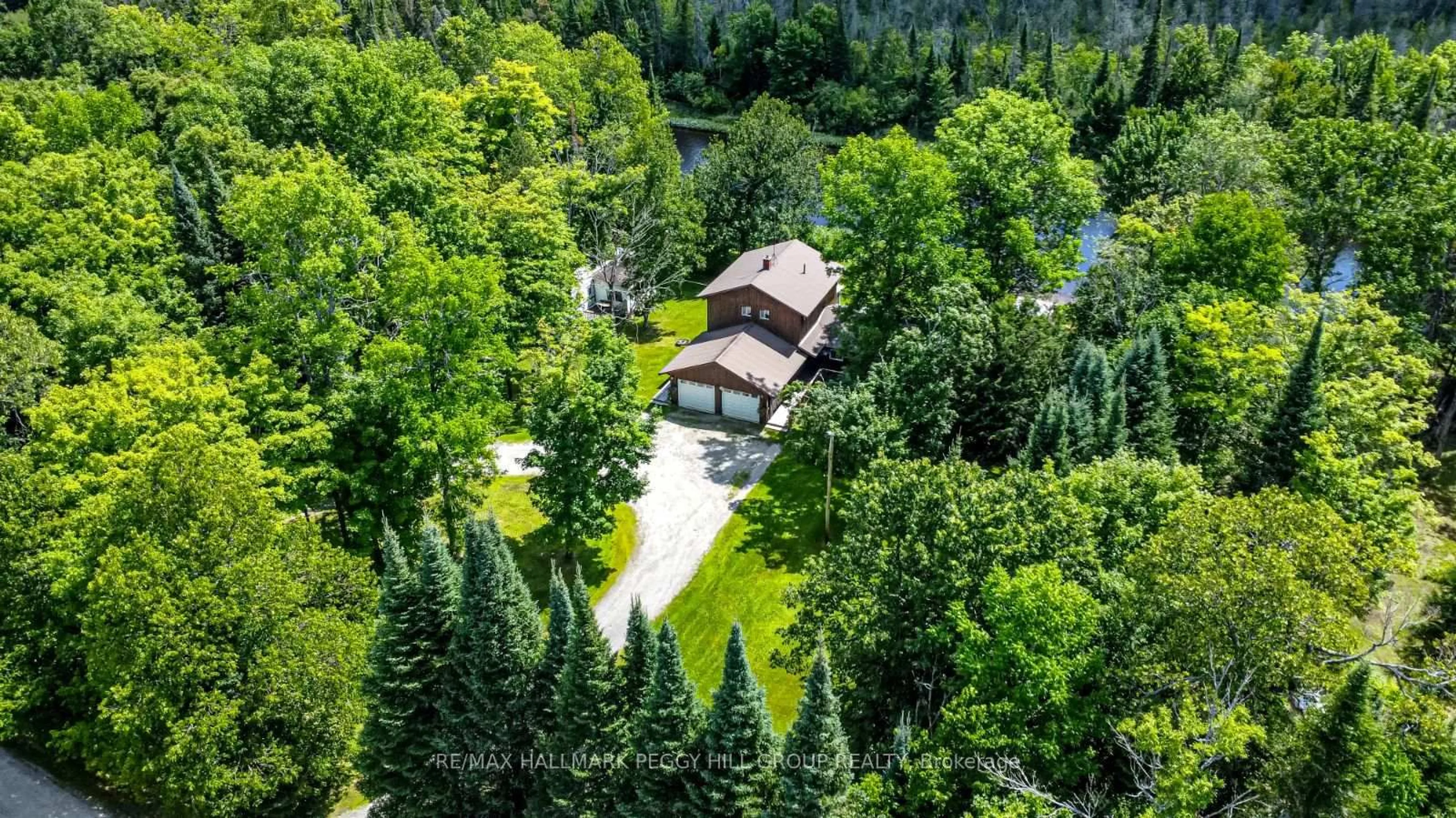 A pic from outside/outdoor area/front of a property/back of a property/a pic from drone, forest/trees view for 483 Spring Hill Rd, Ryerson Ontario P0A 1C0