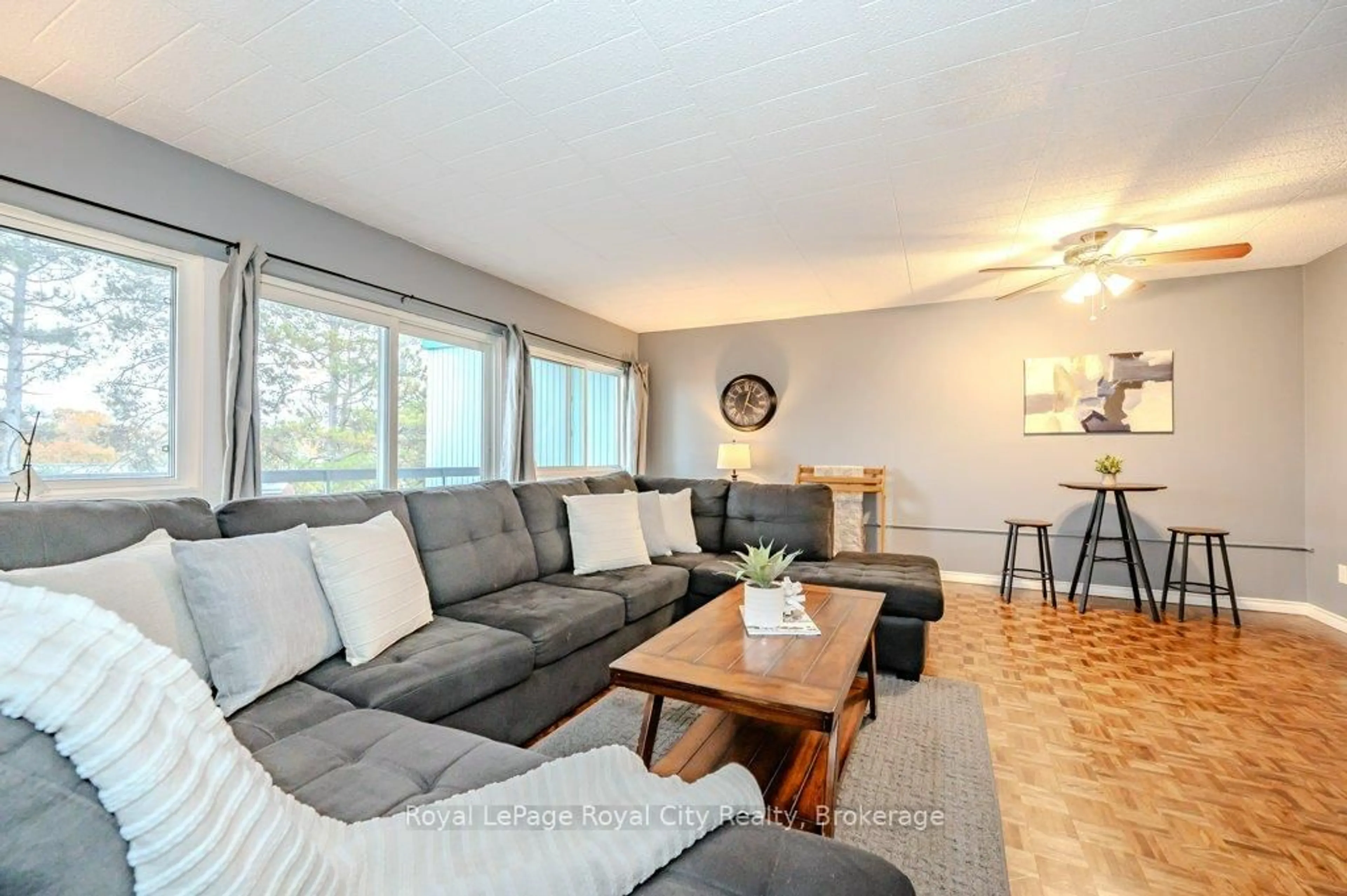 Living room with furniture, wood/laminate floor for 105 Conroy Cres #511, Guelph Ontario N1G 2V5