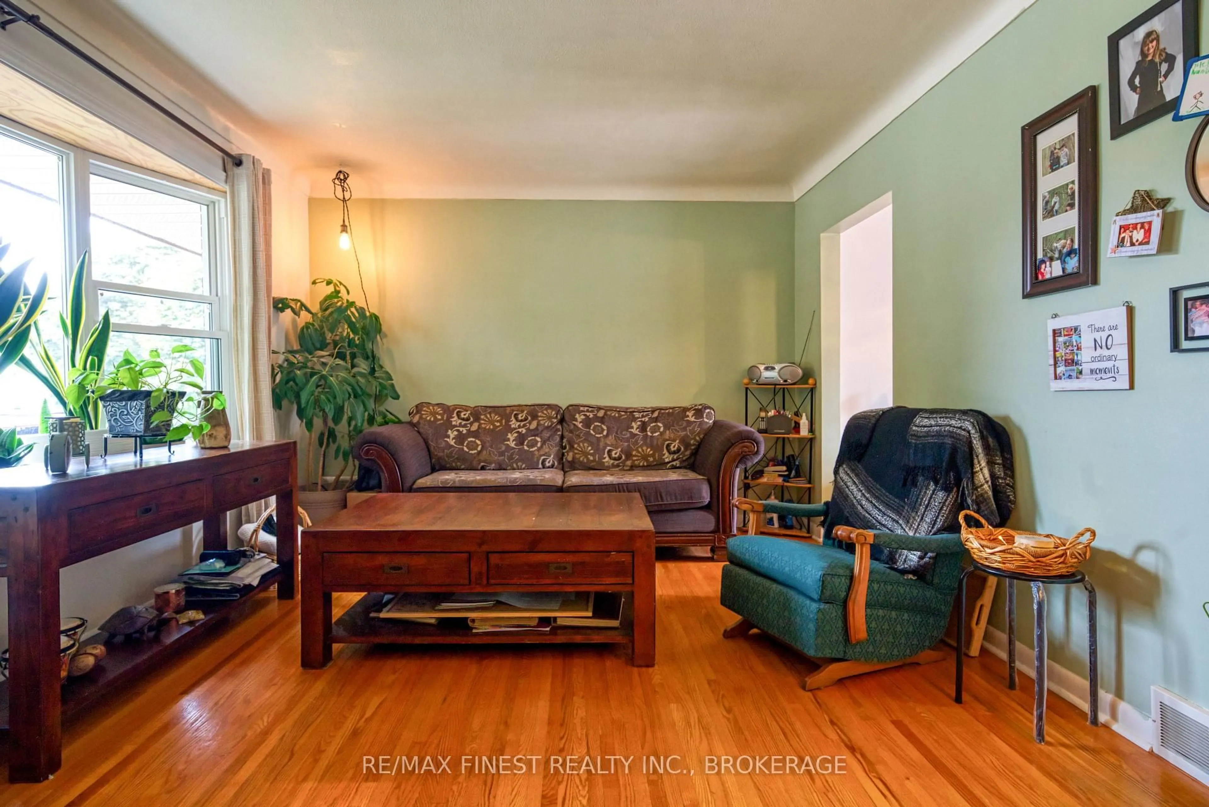 Living room with furniture, wood/laminate floor for 107 Casterton Ave, Kingston Ontario K7M 1R9